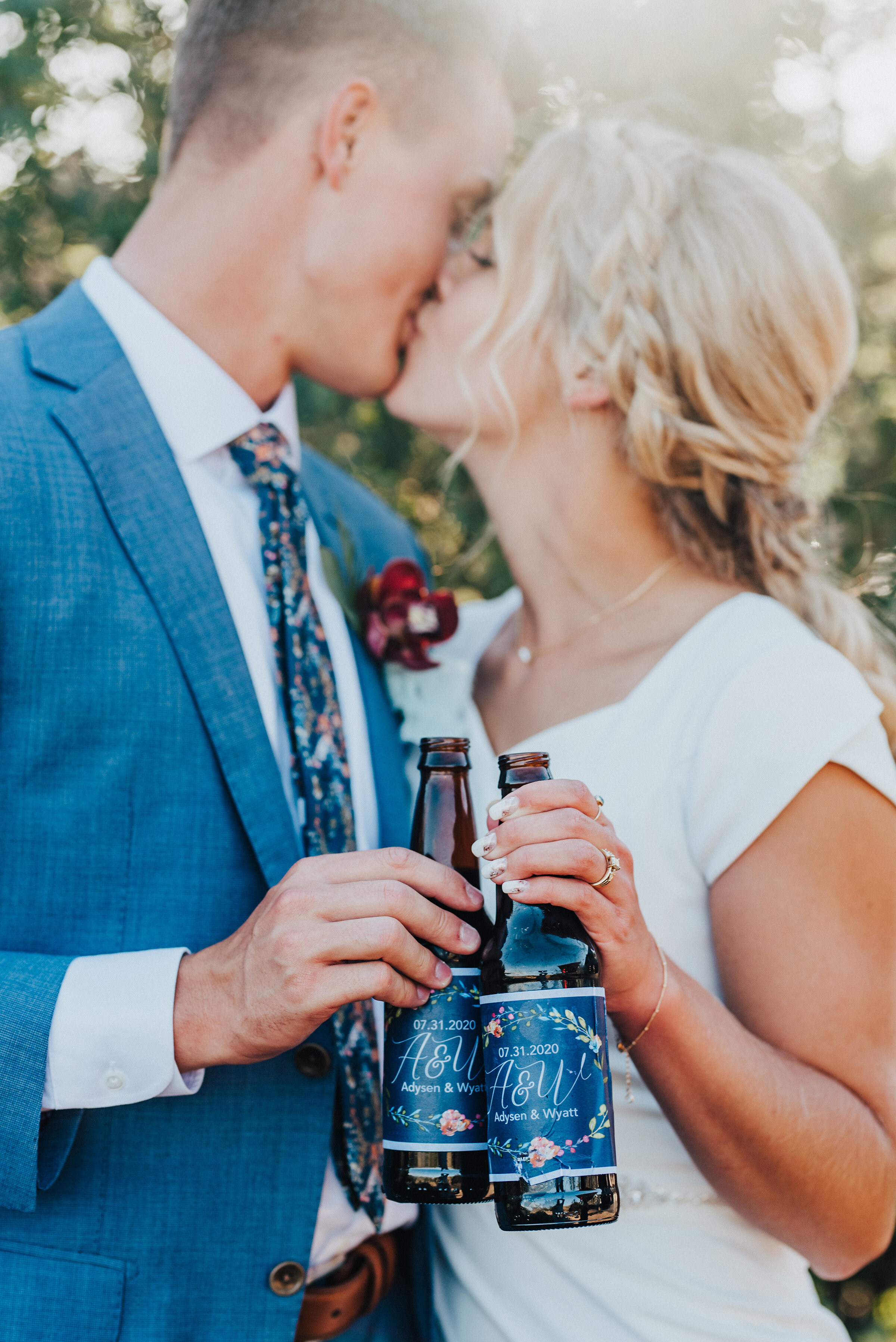  Locking lips with drinks in hand for these two newlyweds at their backyard wedding reception in Park City. Kristi Alyse Photography Logan Utah photographer Park City wedding photographer Drive-Thru wedding COVID wedding neon signs socially distant w