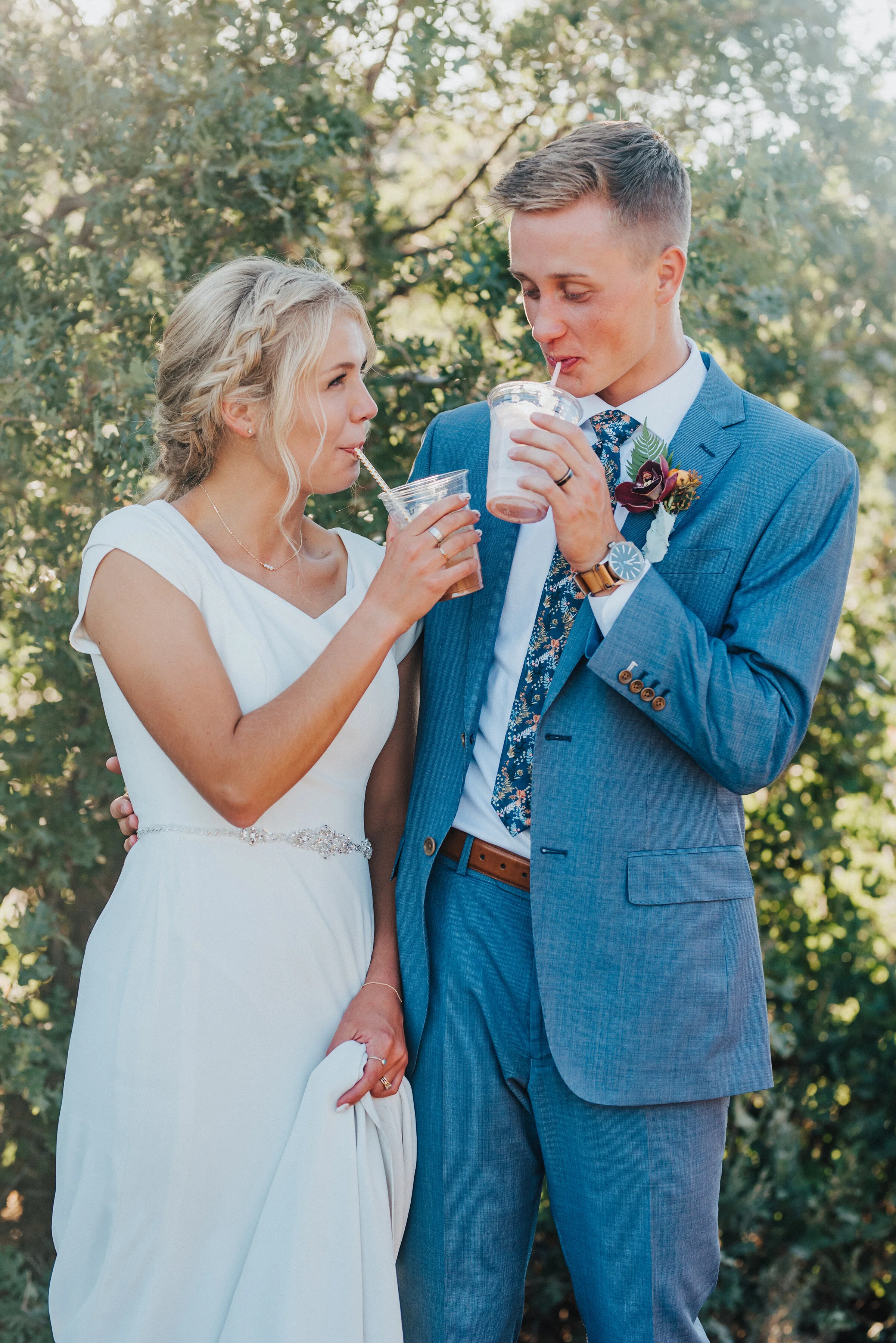  Cute newlyweds sipping drinks at their socially distant wedding reception in Park City. Kristi Alyse Photography Logan Utah photographer Park City wedding photographer Drive-Thru wedding COVID wedding neon signs socially distant wedding bride and gr