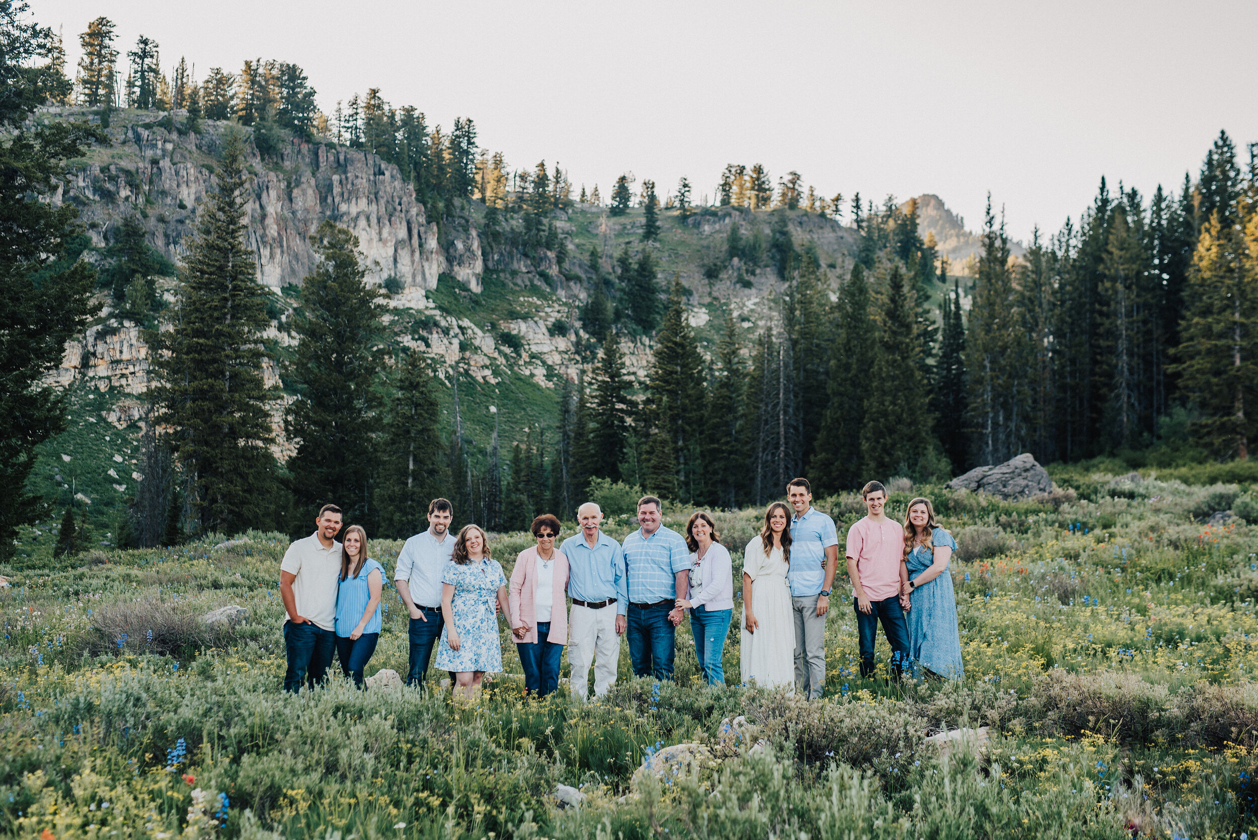 Striking family photo shoot in a gorgeous meadow up Logan canyon at Tony Grove. Logan Utah family photographer Kristi Alyse photography Tony Grove forest nature photos Logan canyon light blue family photos wild flowers grand parents children parents spouses reunited dreamy scenic photo shoot #kristialysephotography #utahphotographer #familyphotography #logancanyon #familyphotos #forest #wildflowers #northernutah #familyportraits #family