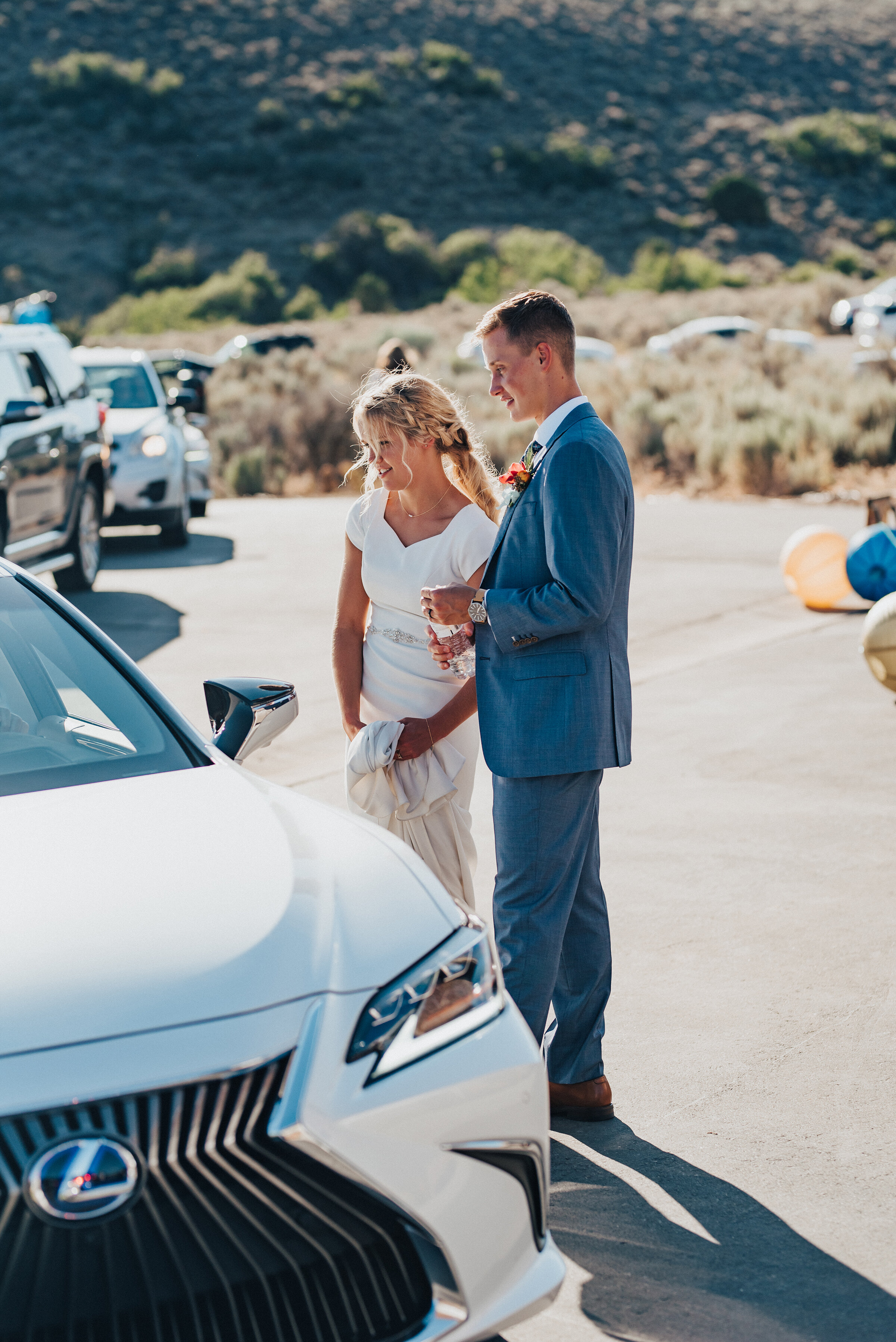  Socially distant bride and groom greeting wedding guests at their drive-thru wedding reception in Park City Utah. Kristi Alyse Photography Logan Utah photographer Park City wedding photographer Drive-Thru wedding COVID wedding neon signs socially di