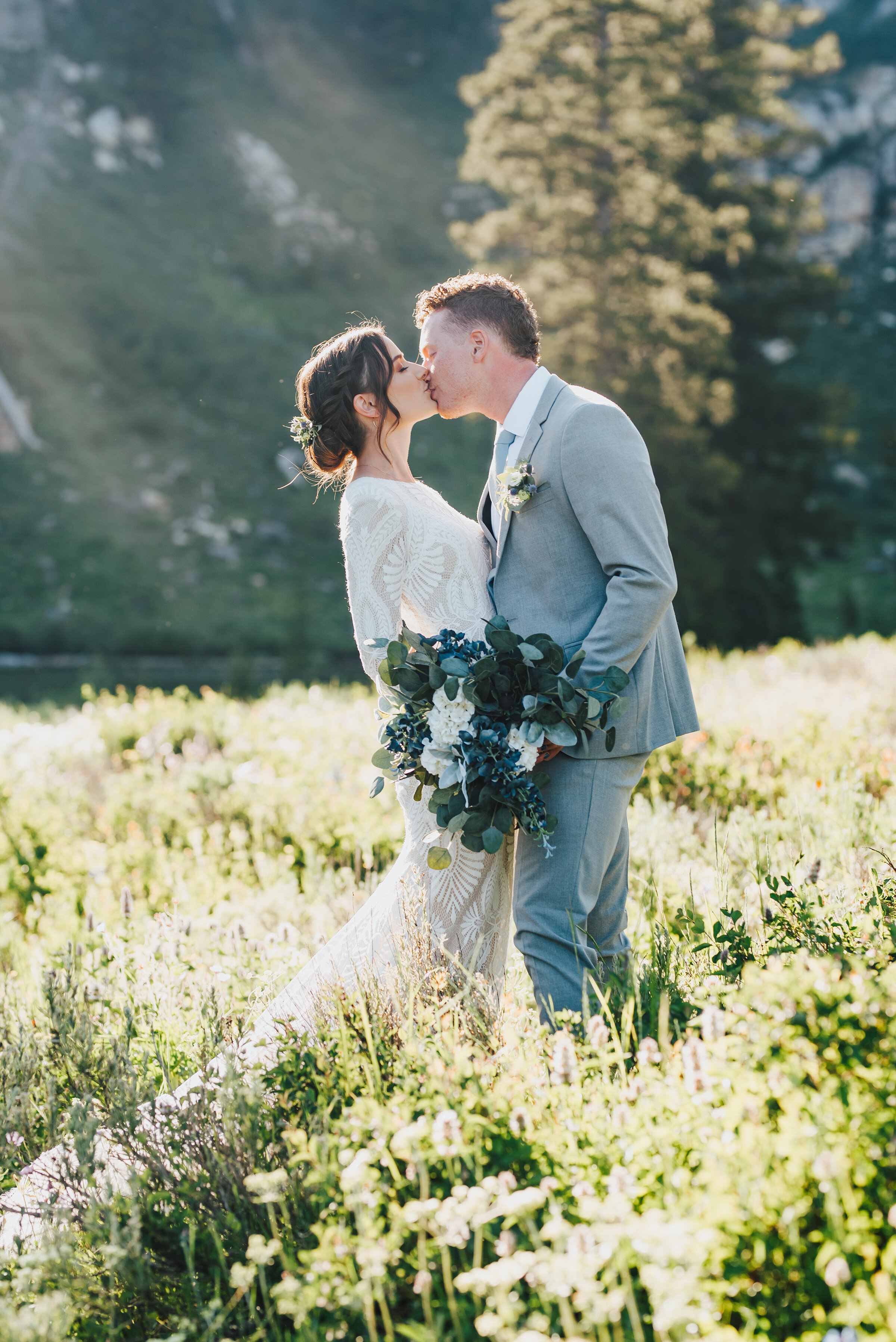  Beautiful bride and groom in a dreamy meadow sharing a kiss during their formals up Logan canyon. Kristi Alyse photography Logan Utah wedding photographer forest nature dreamy formals Logan canyon Tony Grove scenic bridals Northern Utah photographer