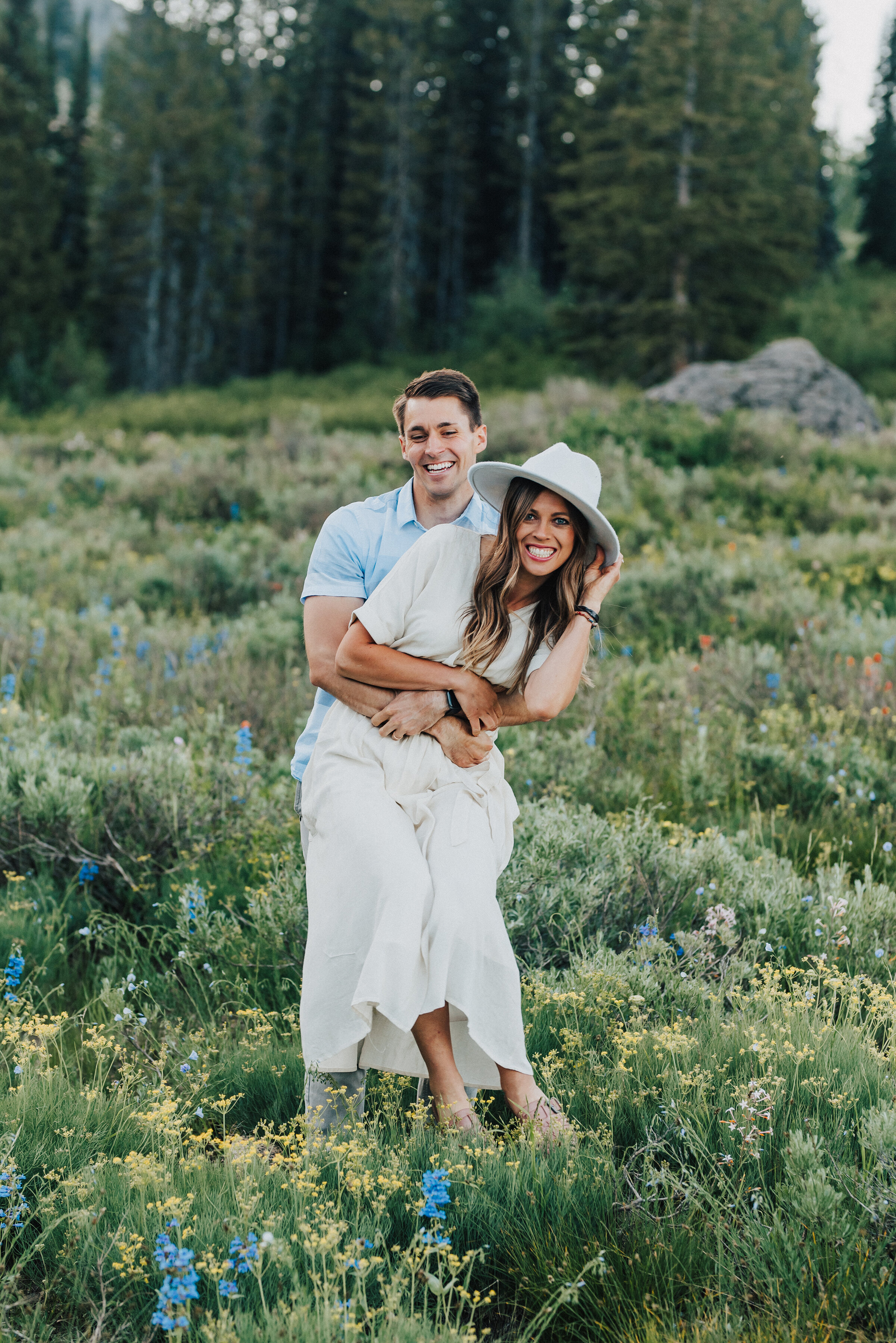  Playful couple during this fun family session up Logan canyon at Tony Grove. Logan Utah family photographer Kristi Alyse photography Tony Grove forest nature photos Logan canyon light blue family photos wild flowers grand parents children parents spouses reunited dreamy scenic photo shoot #kristialysephotography #utahphotographer #familyphotography #logancanyon #familyphotos #forest #wildflowers #northernutah #familyportraits #family 