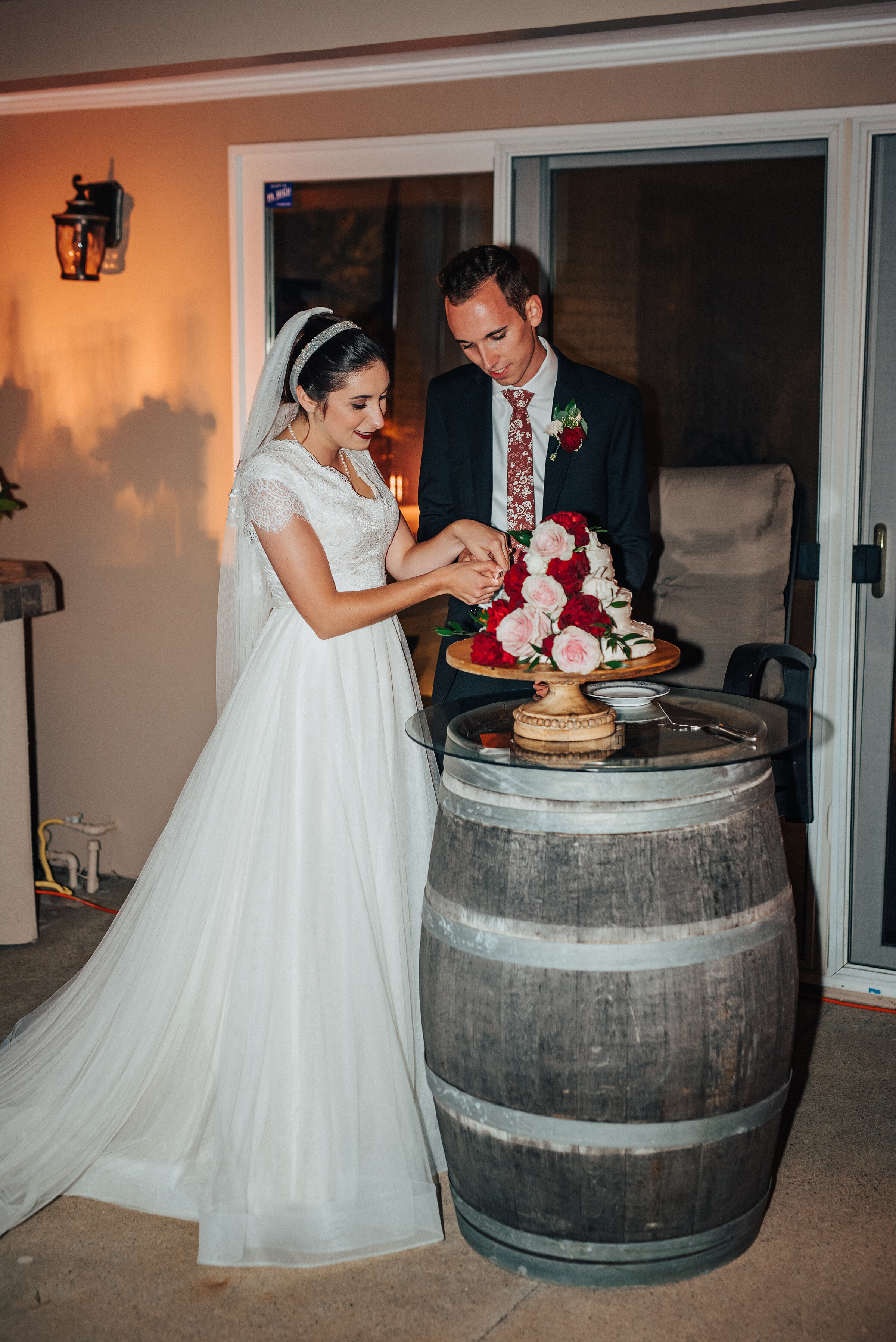  Bride and Groom cutting their wedding cake at this sweet backyard wedding in Laguna Beach. Kristi Alyse photography Laguna Beach wedding California brides Logan Utah wedding photographer backyard wedding destination photographer covid wedding bride 