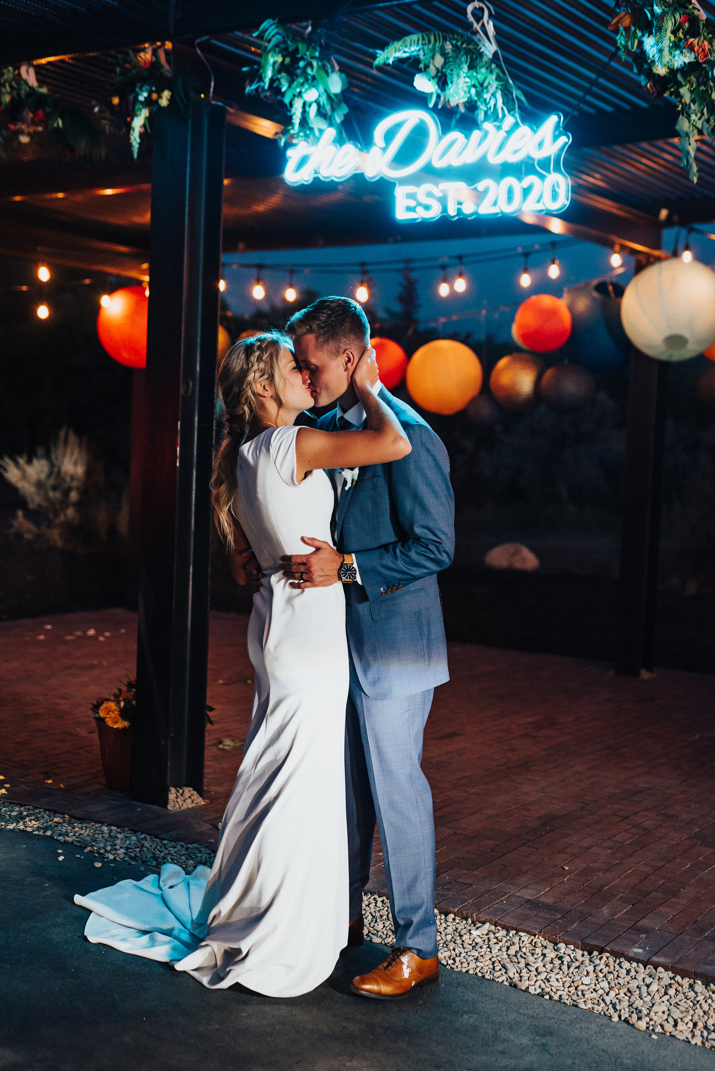 Retro neon sign hovering over this happy newlywed couple at their backyard wedding reception in Park City. Kristi Alyse Photography Logan Utah photographer Park City wedding photographer Drive-Thru wedding COVID wedding neon signs socially distant w…