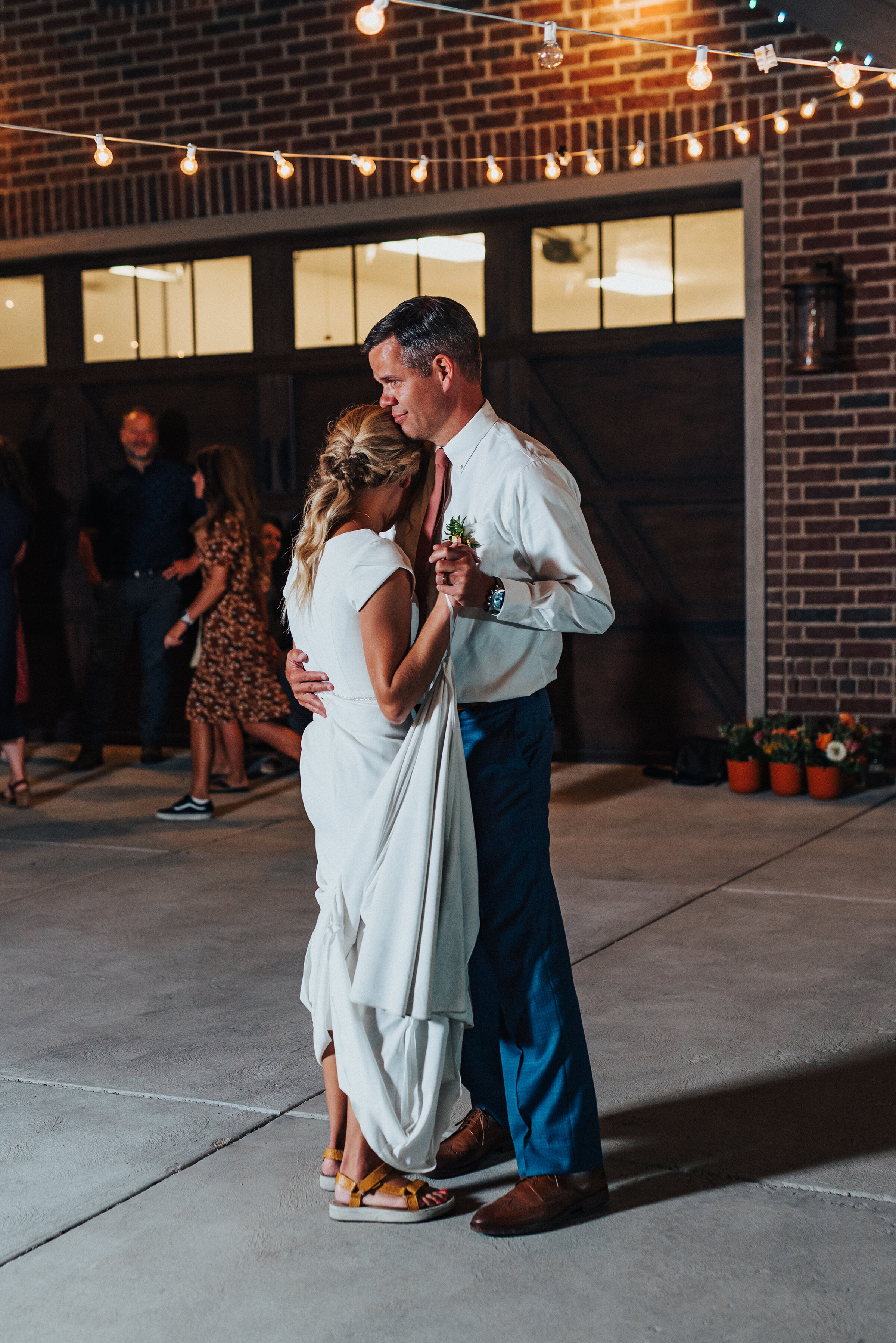  Father of the bride dancing with his daughter at her backyard wedding reception in Park City. Kristi Alyse Photography Logan Utah photographer Park City wedding photographer Drive-Thru wedding COVID wedding neon signs socially distant wedding bride 