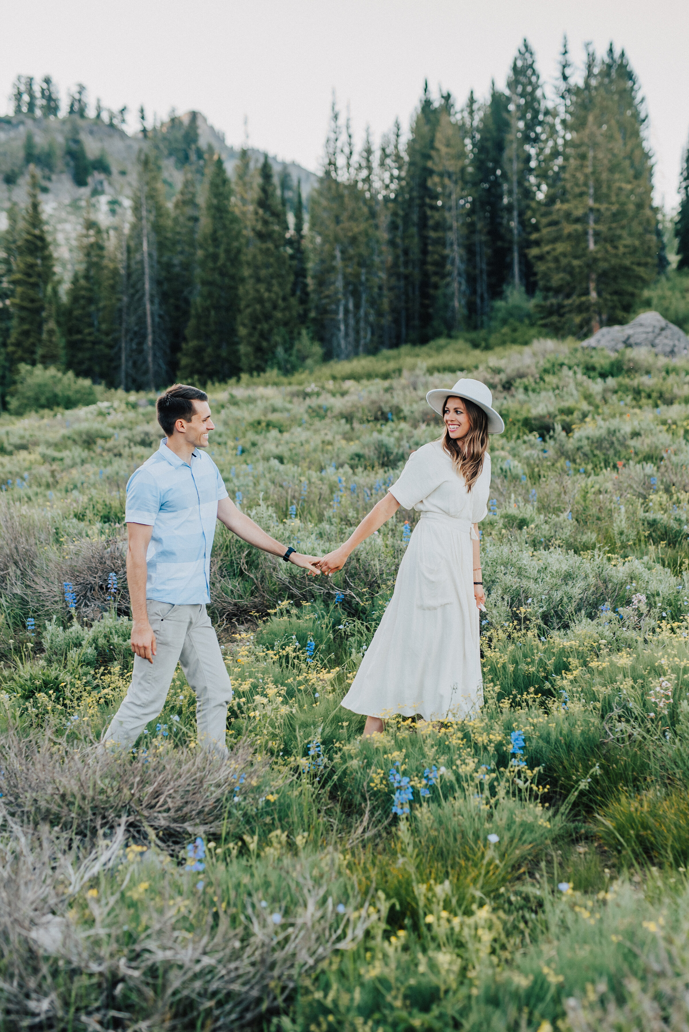  Stunning couple walking through meadows up Logan canyon for this lovely family photo session. Logan Utah family photographer Kristi Alyse photography Tony Grove forest nature photos Logan canyon light blue family photos wild flowers grand parents ch