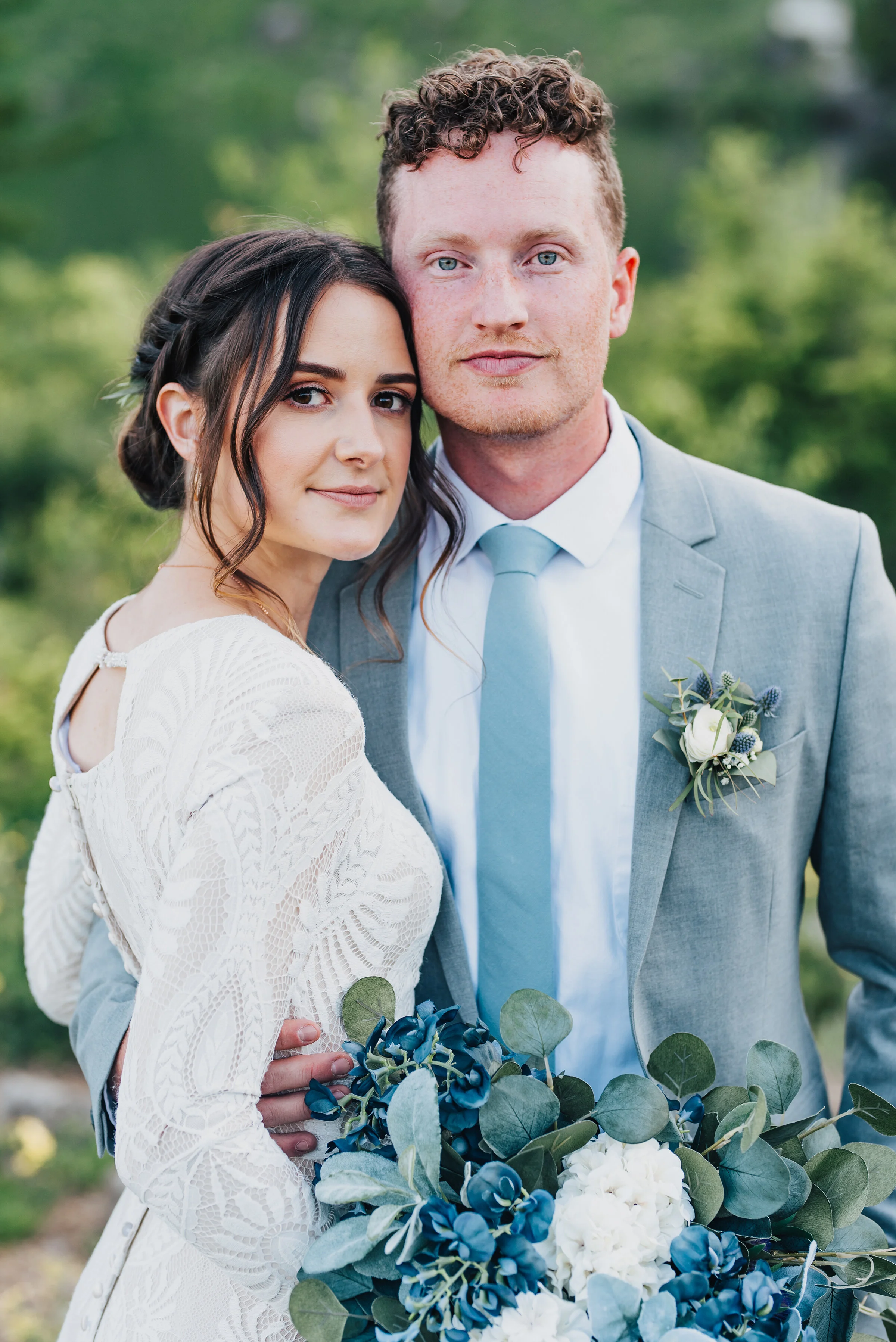  Striking bride and groom holding stunning handpicked bouquet during their formals up Logan canyon. Kristi Alyse photography Logan Utah wedding photographer forest nature dreamy formals Logan canyon Tony Grove scenic bridals Northern Utah photographe