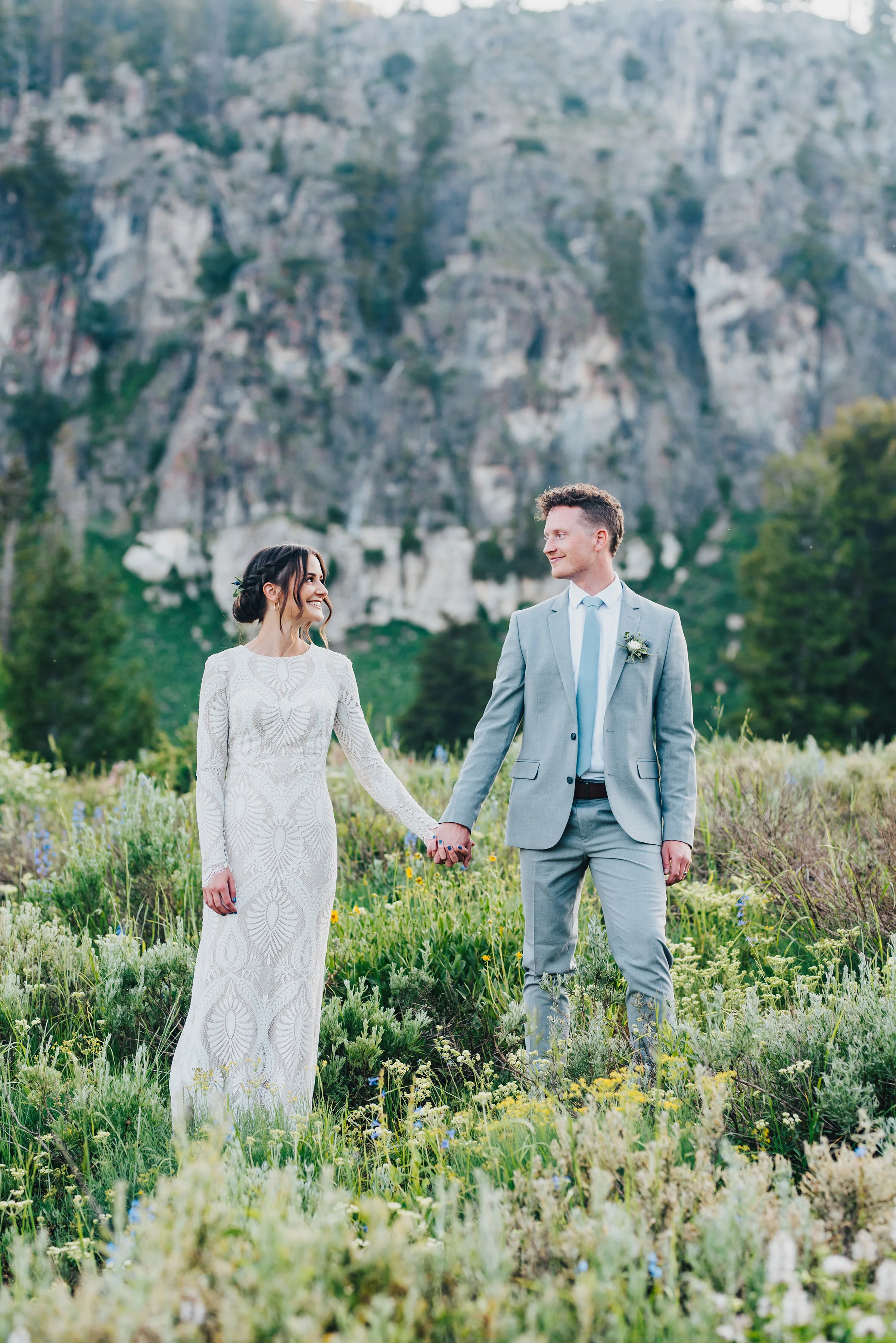  Two lovers holding hands in a meadow during their formals up Logan canyon at Tony Grove. Kristi Alyse photography Logan Utah wedding photographer forest nature dreamy formals Logan canyon Tony Grove scenic bridals Northern Utah photographer Utah bri