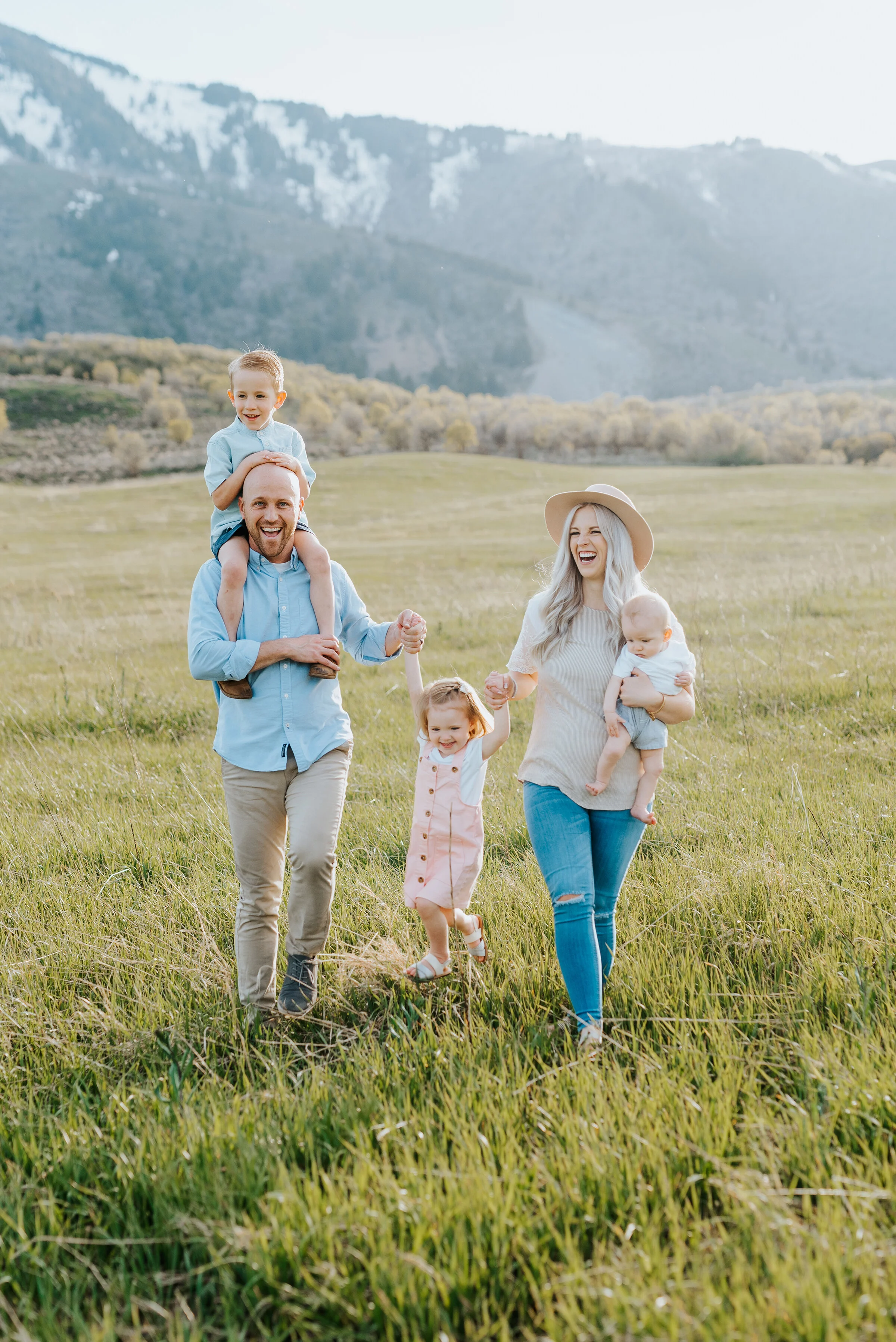  Happy family looks into camera during a logan utah family photoshoot capturing their love forever. Family photoshoot inspiration logan utah family photo locations mountain family photoshoot locations happy family families are forever family photogra