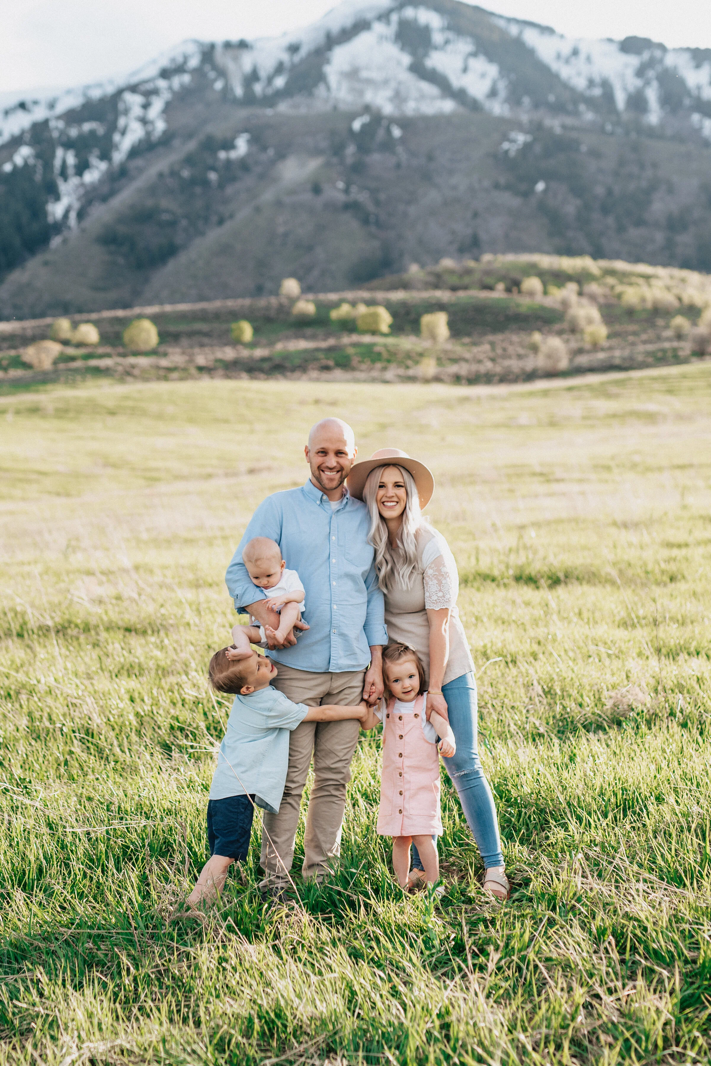  Family poses effortlessly in the wellsville mountains during a logan utah group photoshoot. Krisit Alyse Photography utah based photographer who specializes in family photoshoots group photo ideas family photos with three children family pose ideas 