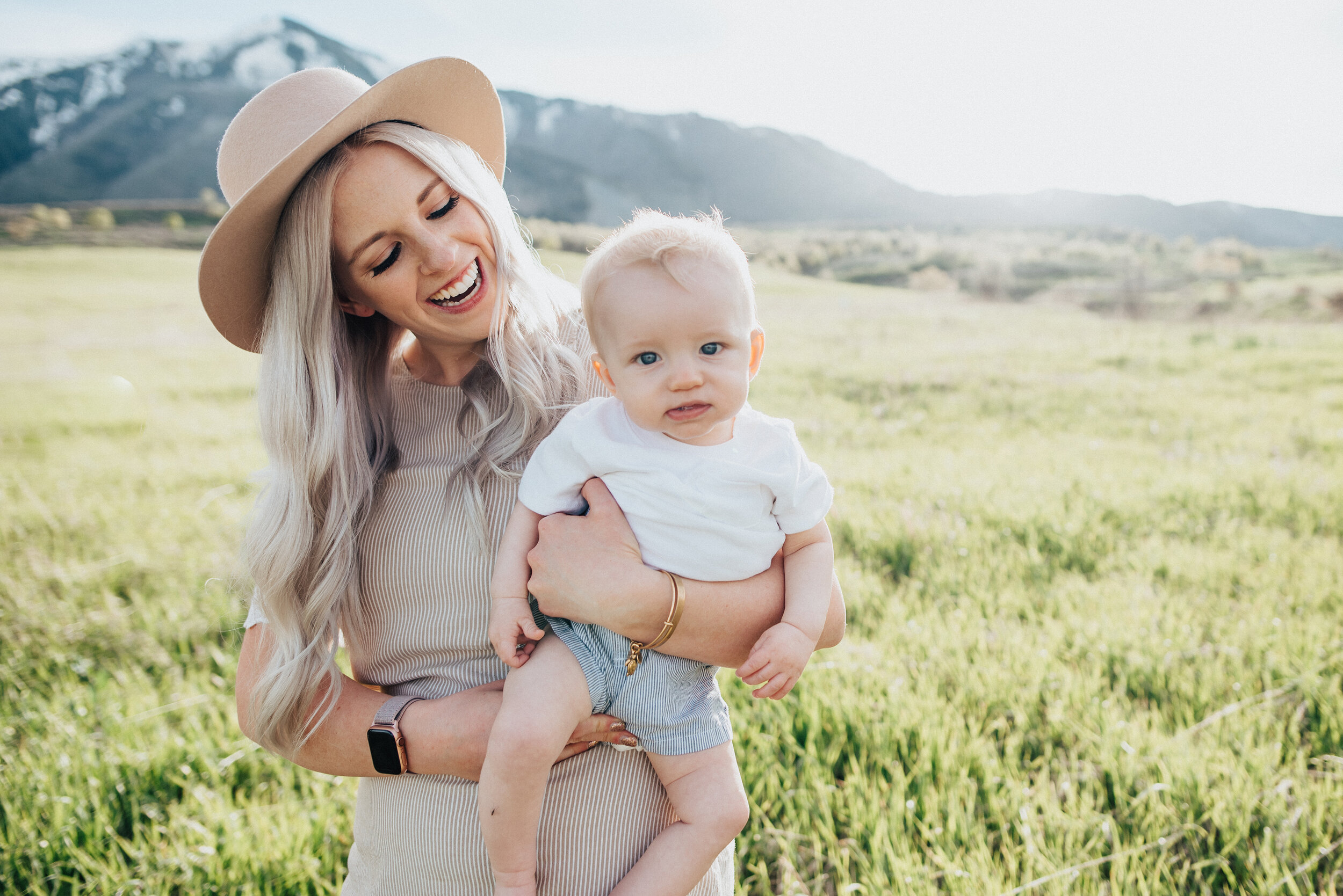  Mom holds son while smiling at his cute face during an unforgettable utah family photoshoot. Adorable mom and baby photos mamas boy utah photography kristi alyse photography family photographer for babies mama bear photography #momanddad #mommylove 