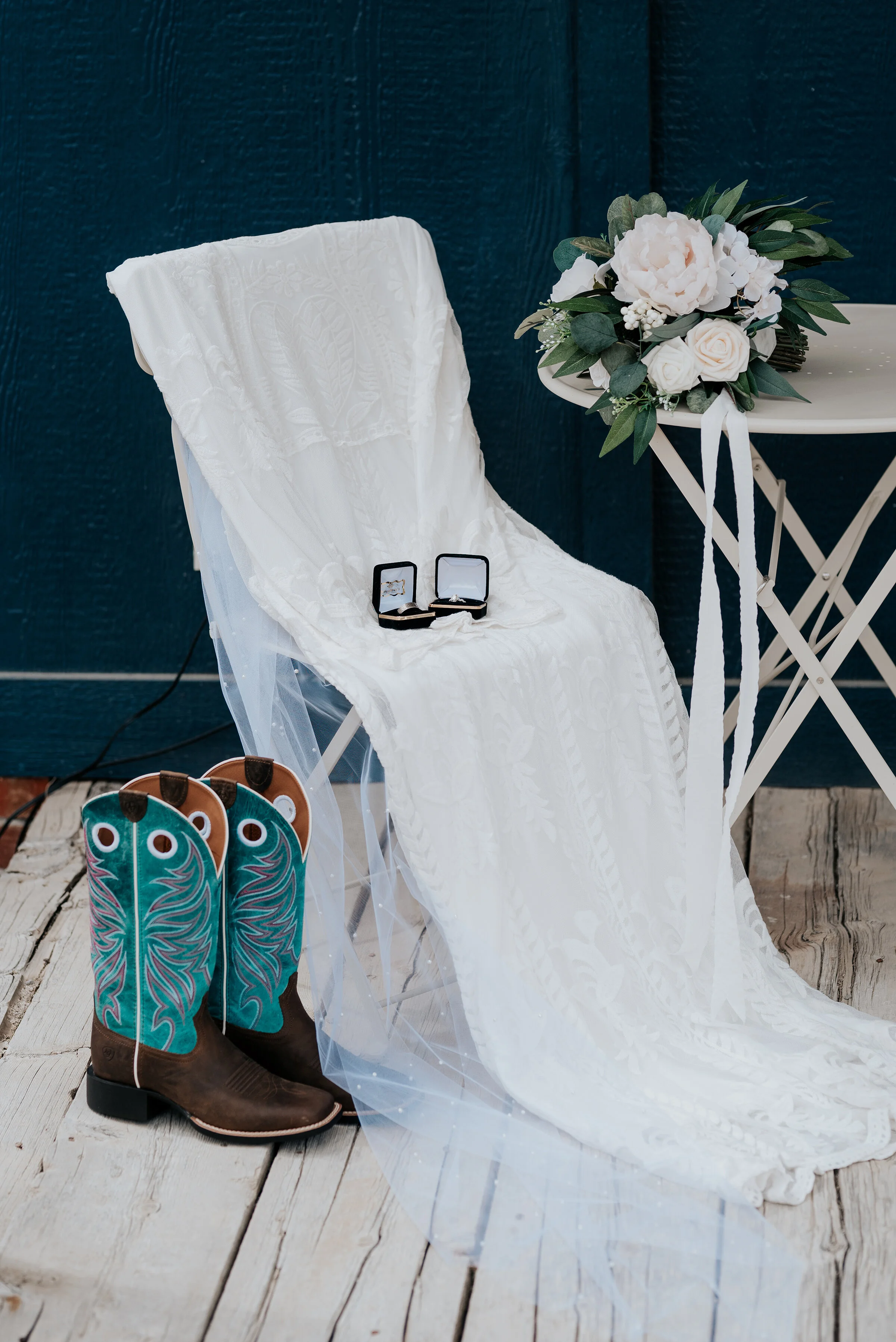 Stunning turquoise blue cowgirl boots with flares of pink accented the gorgeous tule wedding gown the bride wore on her wedding day. Wedding day photoshoot in Ephraim Utah photography wedding outdoor location western inspired rustic Airbnb photo aes…