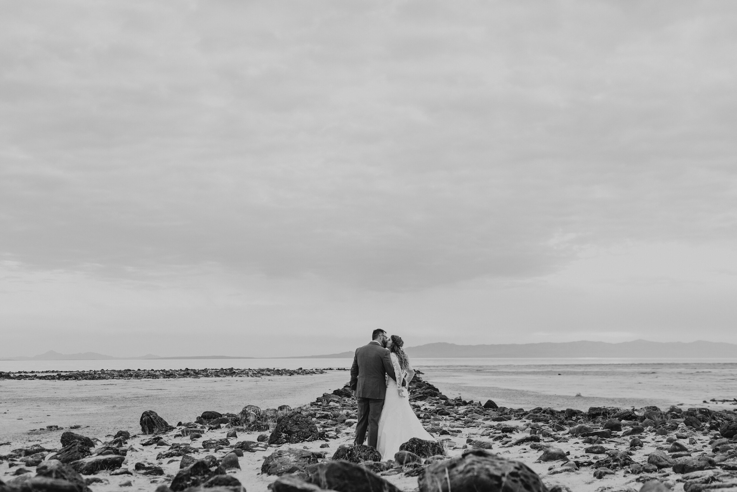  The bride and groom taking in all the excitement and natural beauty of their wedding formal photo session as they prepare to get married. Wedding formal photoshoot in Spiral Jetty Northern Utah Great Salt Lake photography wedding formals natural photo aesthetic bride and groom #spiraljetty #utahphotography #weddingformals #gettingmarried #weddingattire #utahwedding #greatoutdoorswedding #weddingformalsphotoshoot #naturalbeauty 