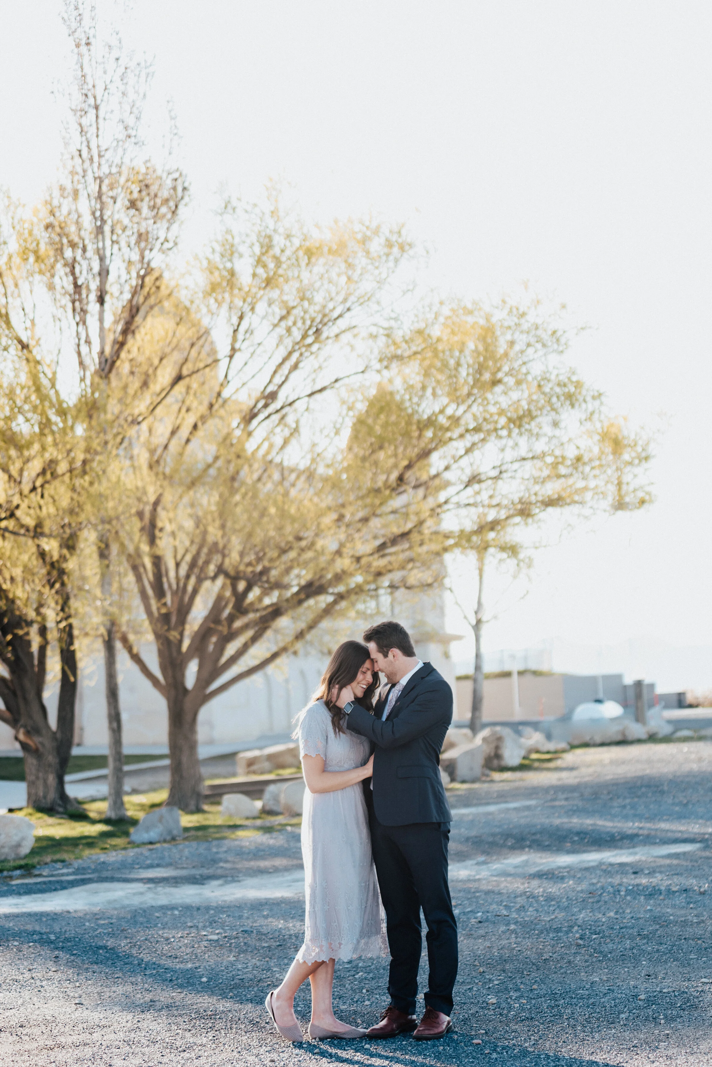  Happy laughing couple pose outside a beautiful building during their utah based engagement photoshoot. Engagement photos happy couple inspiration together forever magna utah photography locations best utah wedding photographer #engagementphotos Kris