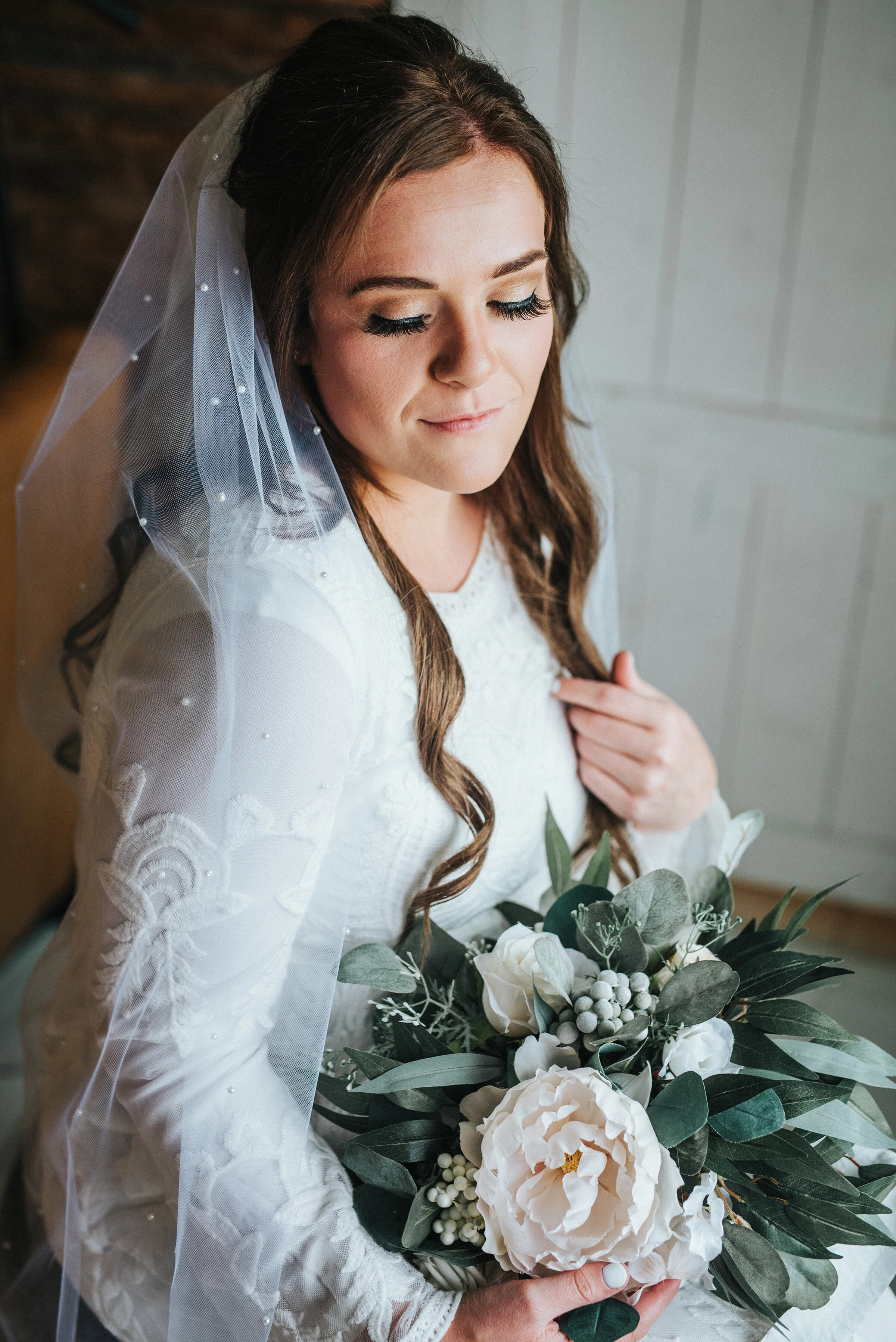  The bride absolutely glowing after the final touches were applied on her wedding day. The curls in her hair and the makeup applied were stunning and her veil was just the right accent piece. Wedding day photoshoot in Ephraim Utah photography wedding