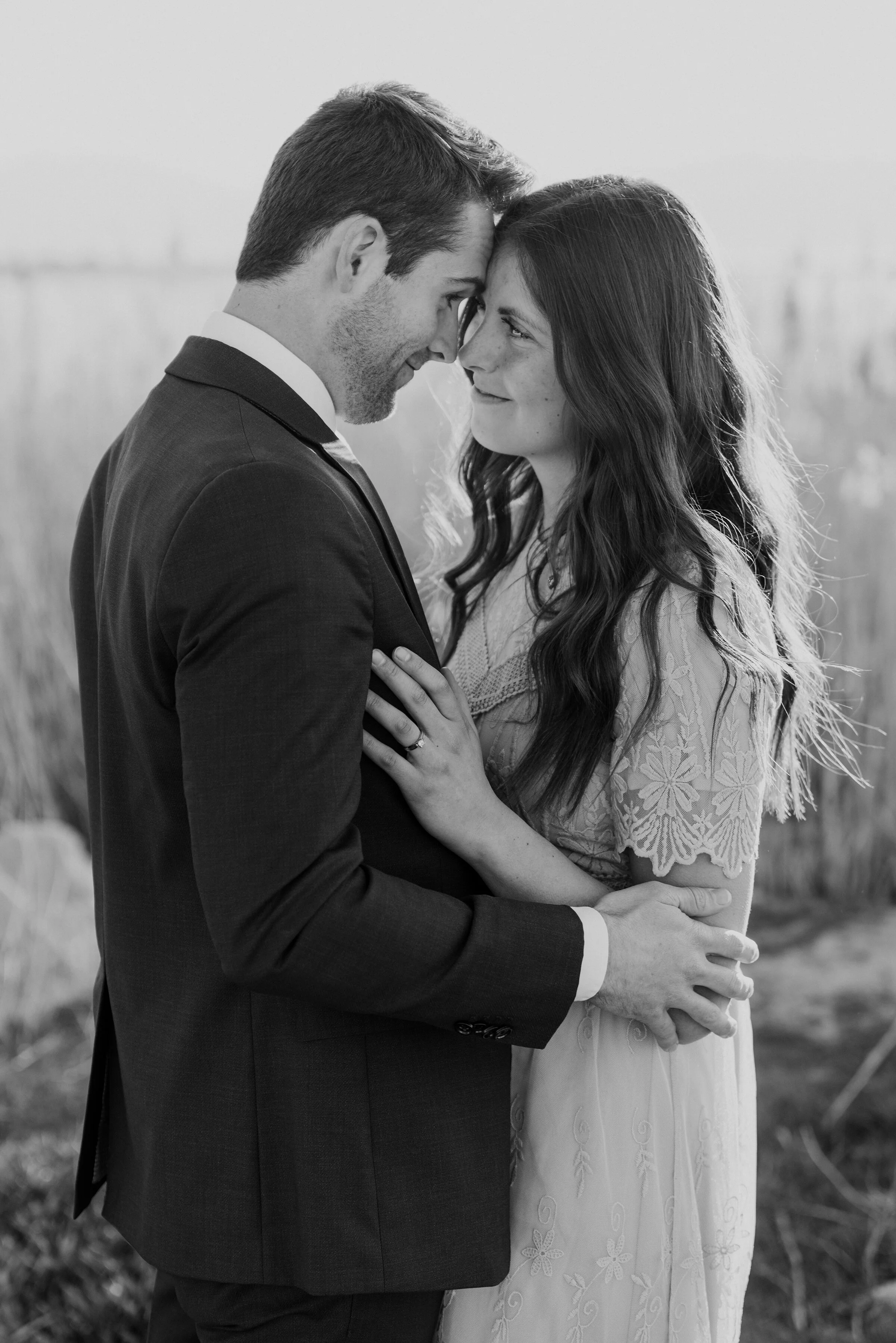  Happy couple blissfully looks at one another in a black and white photo during their engagement photoshoot. black and white photos romantic engagement photography swoonworthy photos couple pose ideas pinterest-worthy photos utah engagement photos bl