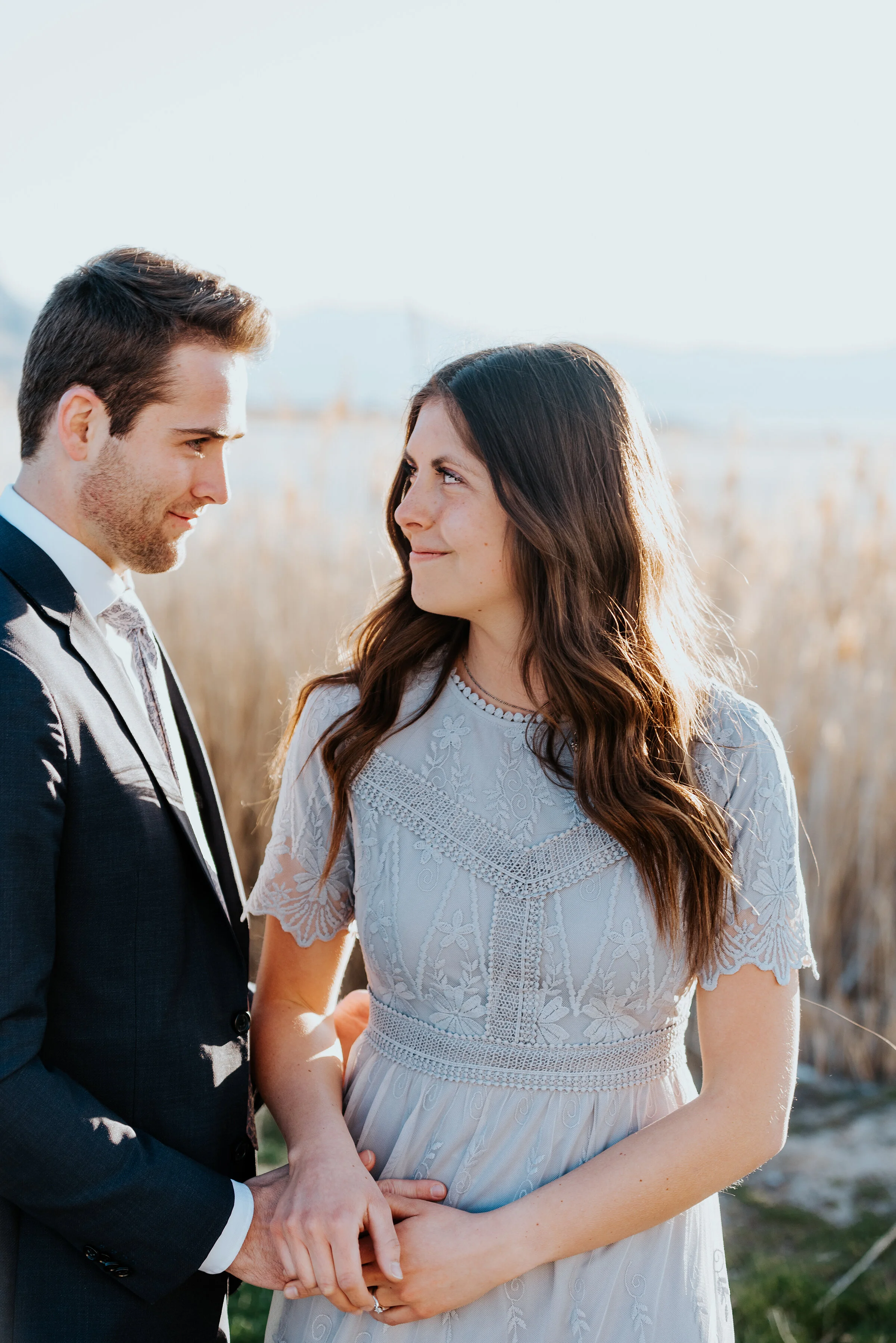  Happy couple blissfully looks at one another and smiles during their engagement photoshoot. Smiling photos romantic engagement photography swoonworthy photos couple pose ideas pinterest-worthy photos utah engagement photos blissful photography #coup
