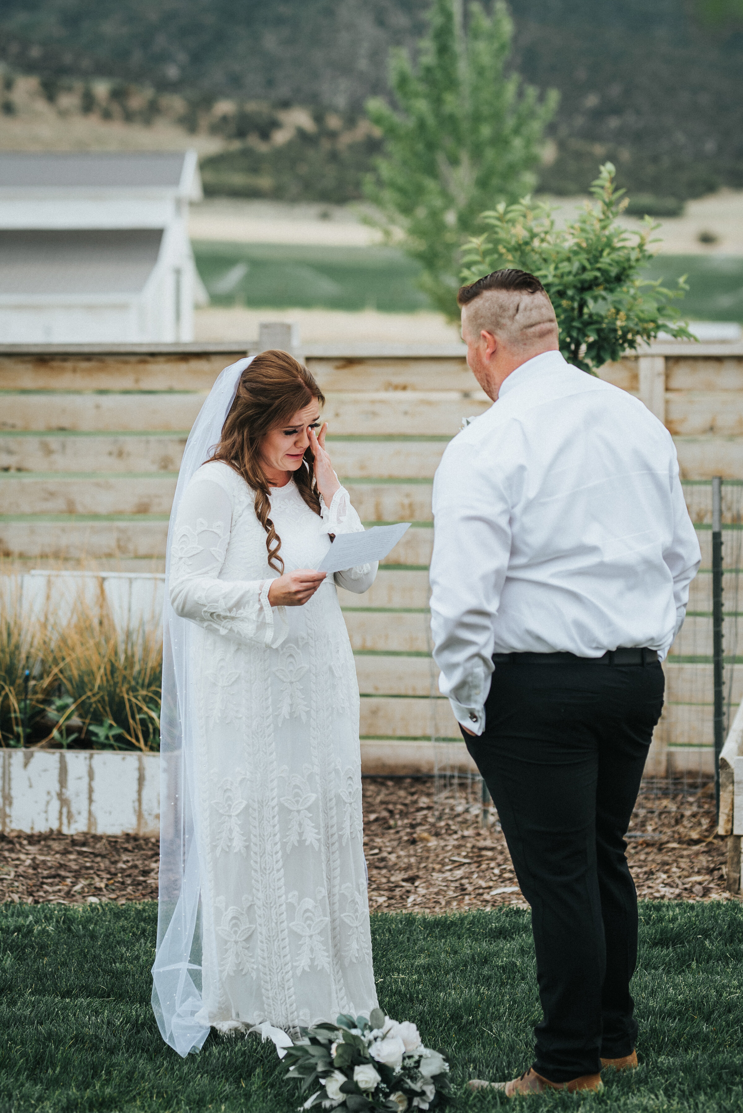  Wedding day vow exchange between the bride and the groom during their intimate outdoor wedding ceremony. photoshoot in Ephraim Utah photography wedding outdoor location western inspired rustic Airbnb photo aesthetic #ephraimutah #utahphotography #weddingdayphotography #gettingmarried #rusticwedding #utahwedding #westernstyle #weddingphotoshoot 
