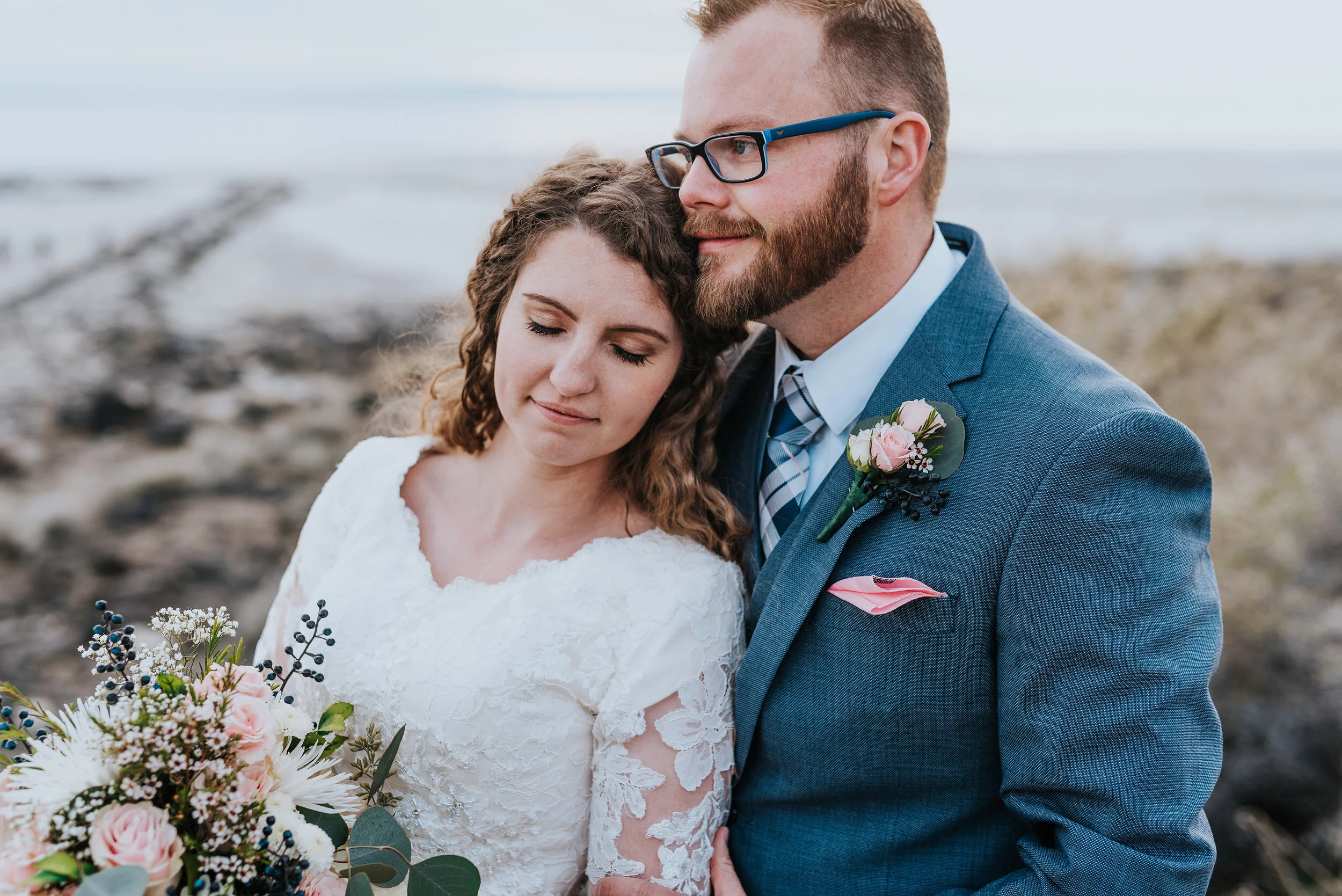  The details this bride and groom displayed were stunning from the light pink pocket square that matched her wedding bouquet to the lace designs on her wedding gown. Stunning wedding formal photoshoot in Spiral Jetty Northern Utah Great Salt Lake pho