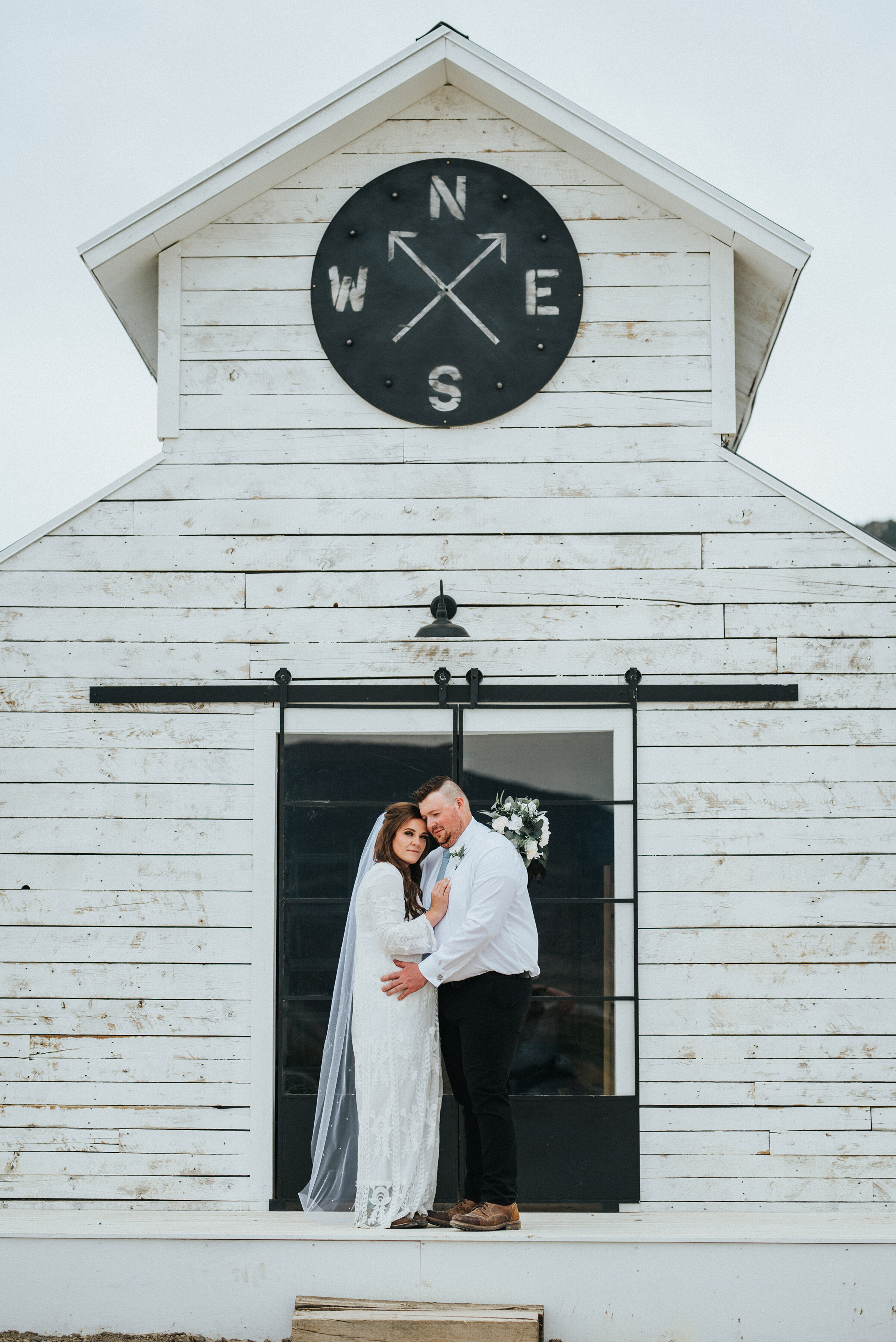  The perfect accent building on this Airbnb property for the bride and groom to stand in front of. White barn rustic western authentic intimate photoshoot in Ephraim Utah photography wedding outdoor location western inspired rustic Airbnb photo aesth
