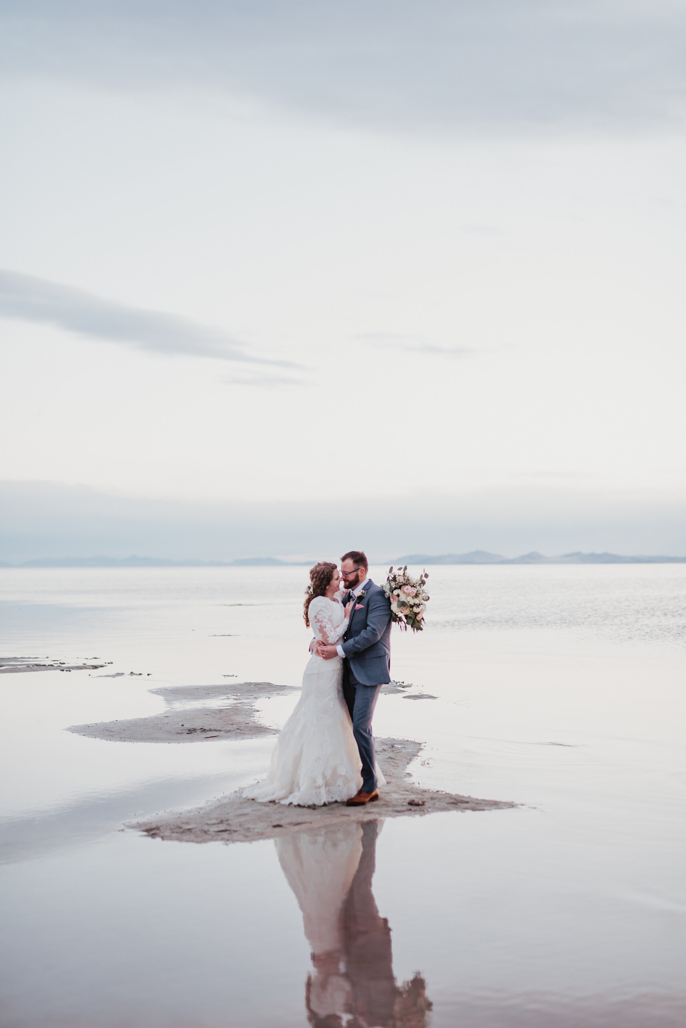  The Spiral Jetty allowed for this bride and groom to captures all of natures beauty and dimension in one photo session. Wedding formal photoshoot in Spiral Jetty Northern Utah Great Salt Lake photography wedding formals natural photo aesthetic bride and groom #spiraljetty #utahphotography #weddingformals #gettingmarried #weddingattire #utahwedding #greatoutdoorswedding #weddingformalsphotoshoot #naturalbeauty 