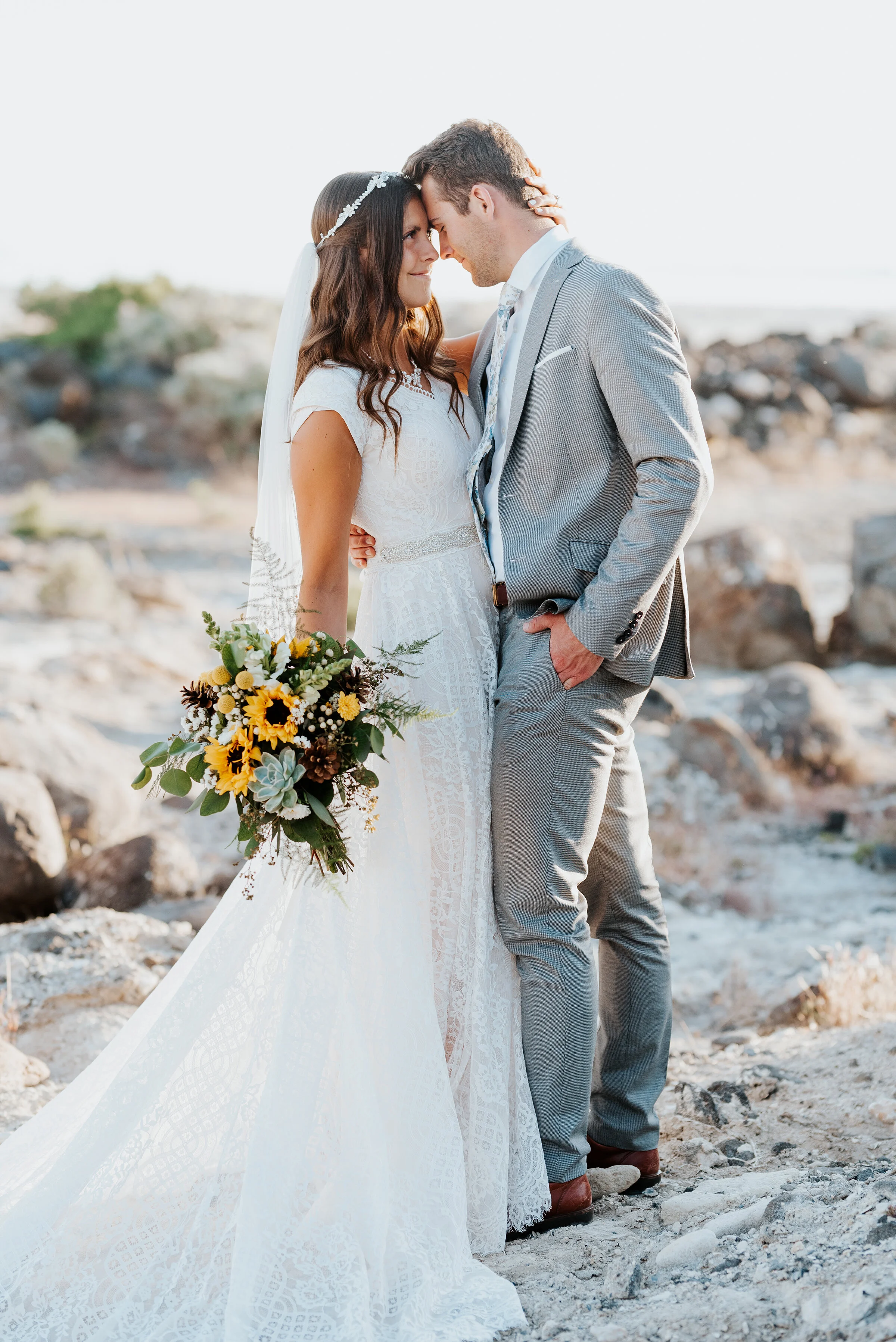  The bride’s sunflower bouquet was gorgeous as the bride and groom stood on the sandy shore of the Great Salt Lake with the rocky Spiral Jetty surrounding them. #spiraljetty #GreatSaltLake #formalsession #SaltFlats #sunsetphotosession #NorthernUtah #