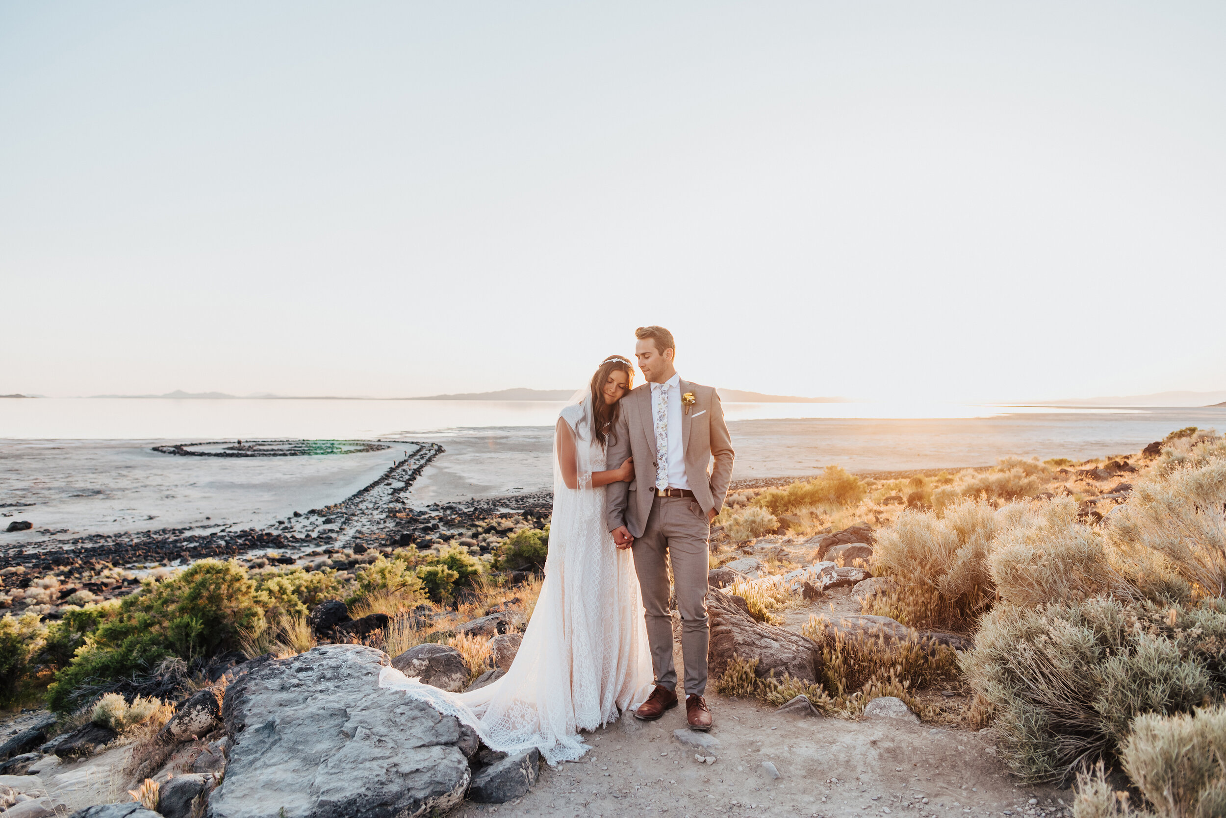  The sunset could not have painted a picture any more gorgeous than during this sunset formal session for the stunning bride and groom at the Spiral Jetty. #spiraljetty #GreatSaltLake #formalsession #SaltFlats #sunsetphotosession #NorthernUtah #weddi