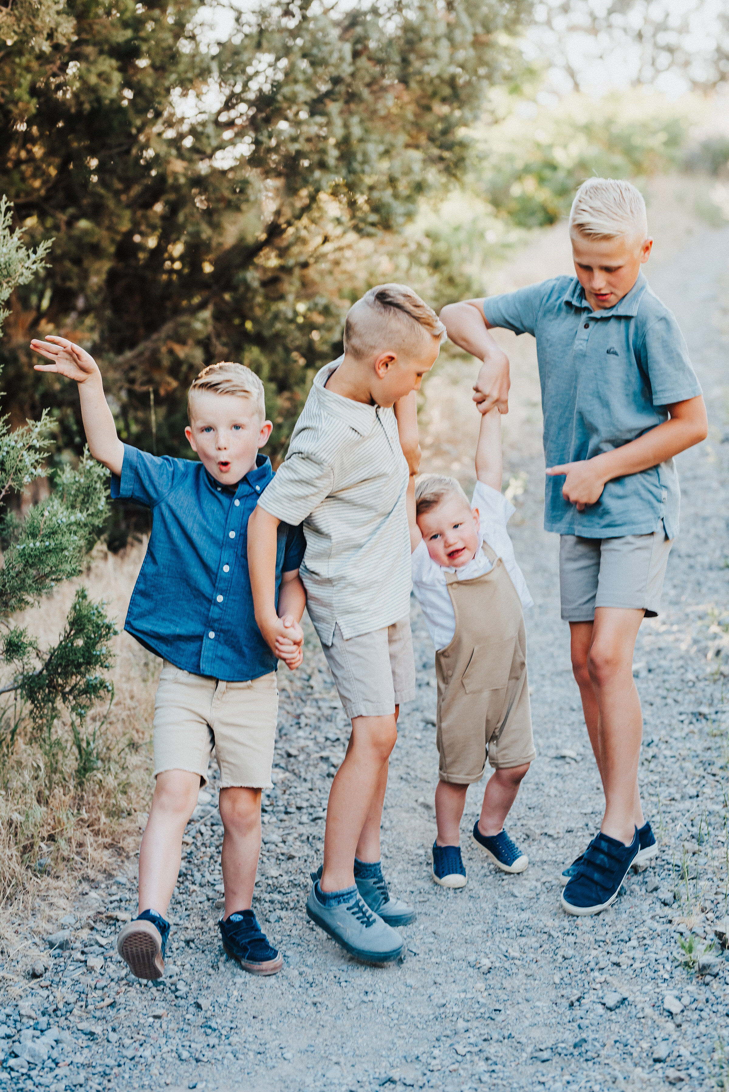  The young brothers all strike various poses while on a trodden path in the canyon. Light blue and khakis soft outdoor setting two boys life youngest boy silly faces #providencecanyon #utahphotography #utah #familyphoto #family #familyphotography #familyphotographer #photography #love #familytime #familyphotoshoot #familyportrait #familyfirst #photooftheday #familyphotos #photographer 