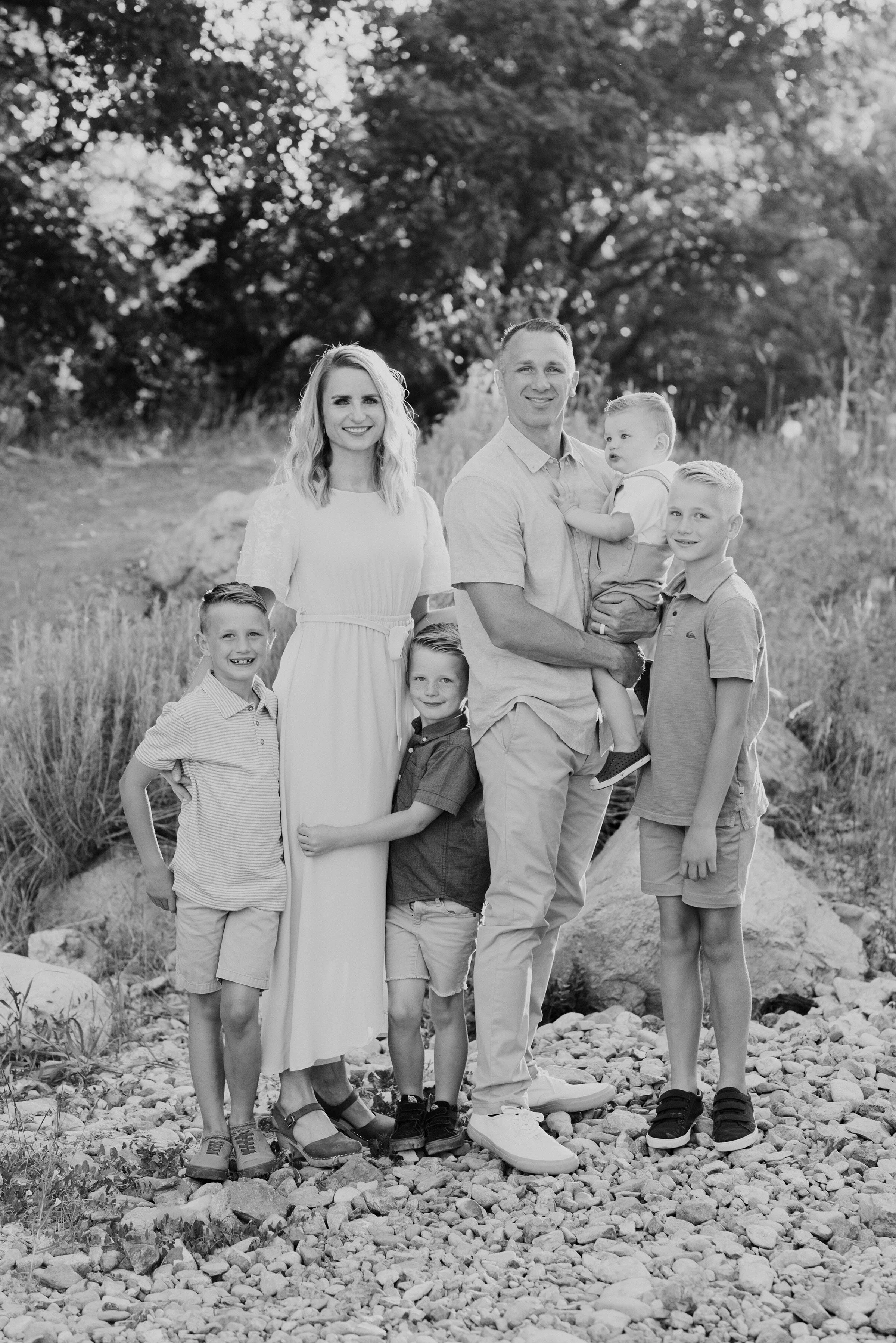 A classic black and white shot of a smiling family of six standing on a stony path in Providence canyon. Black and white photo formal smiles soft outdoor setting utah dessert&nbsp; #providencecanyon #utahphotography #utah &nbsp; #familyphoto #family…