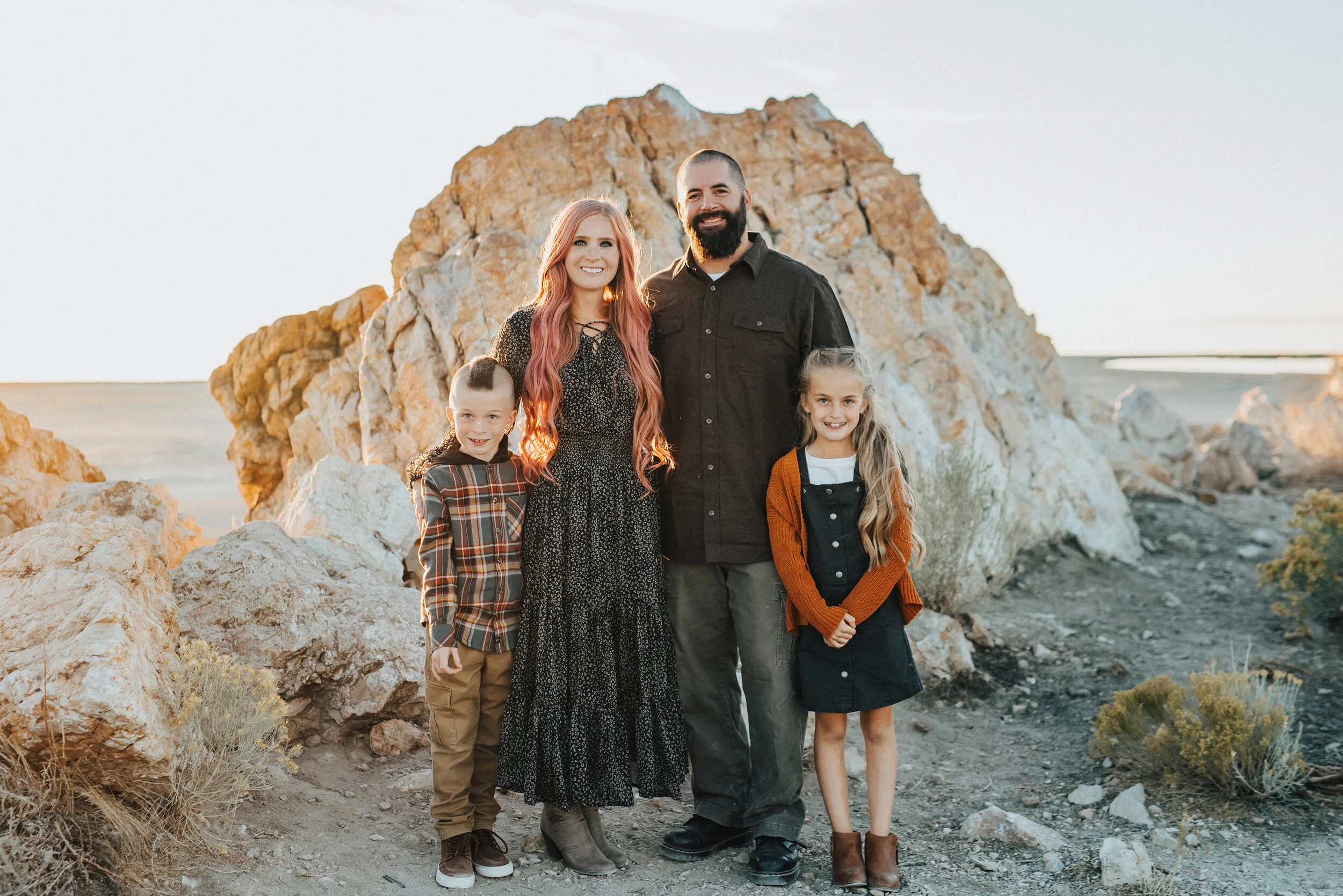 A beautiful family glowing in the rocky hills of Syracuse Utah in an outdoor fall family photo shoot by Kristi Alyse Photography. Fall family outfit inspiration family photo shoot goals ideas and inspiration professional Utah photographer kid outfit…