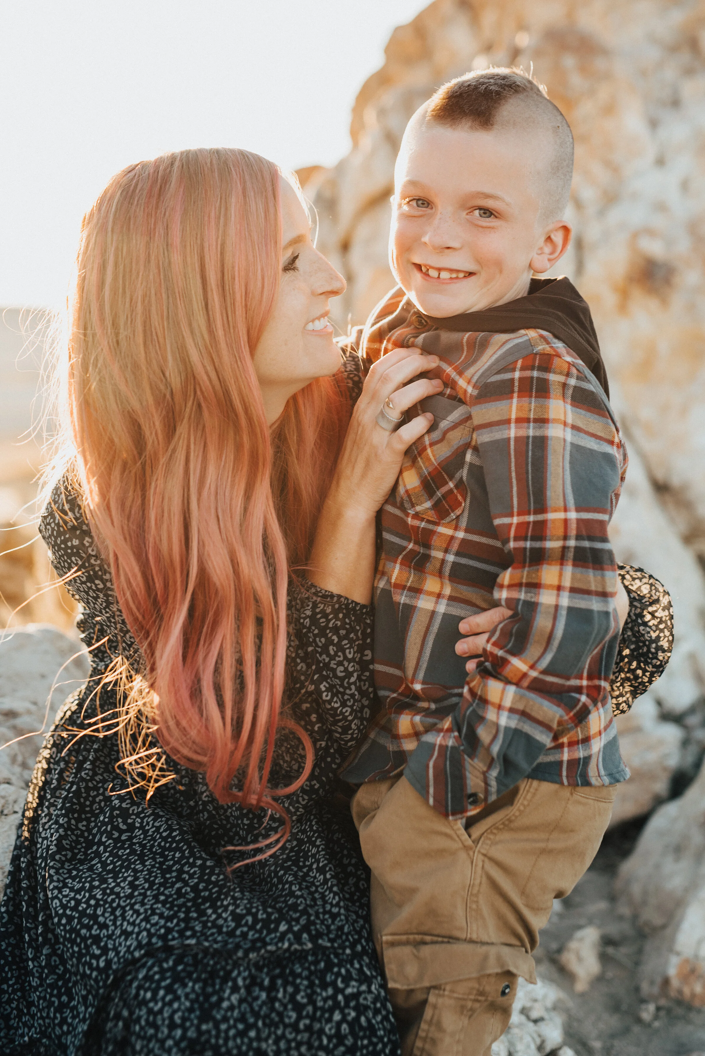  Adorable mother and son pose at Antelope Island by Salt Lake City family photographer Kristi Alyse Photography. Salt lake city family photographer family portraits outfit inspiration pink hair son mohawk plaid family outfits for family pics antelope