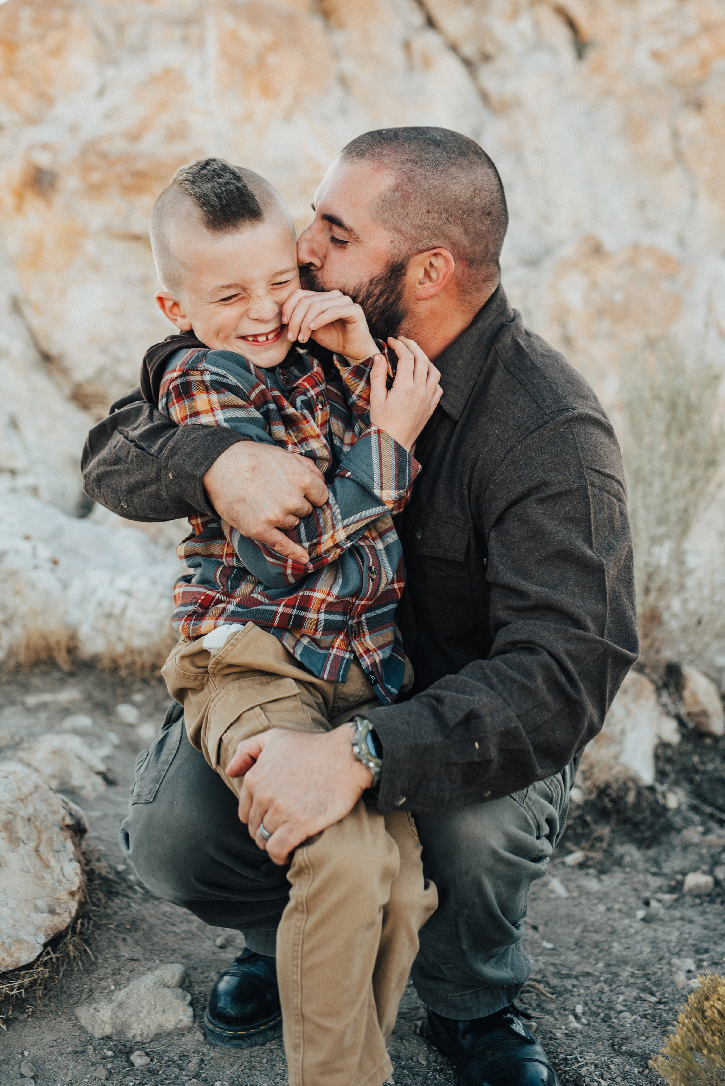  A sweet and playful moment between a father and his son in beautiful family pics by Kristi Alyse Photography. Utah photographer father and son pose inspiration ideas and goals outdoor photo shoot goals family inspiration client attire inspiration Syracuse Utah father and son fun Salt Lake City family pictures #familypictures #utahphotographer #antelopeisland #outfitinspo #familypics #familyphotographer #pinkhair #saltlakecityphotog #slcfamilypictures 