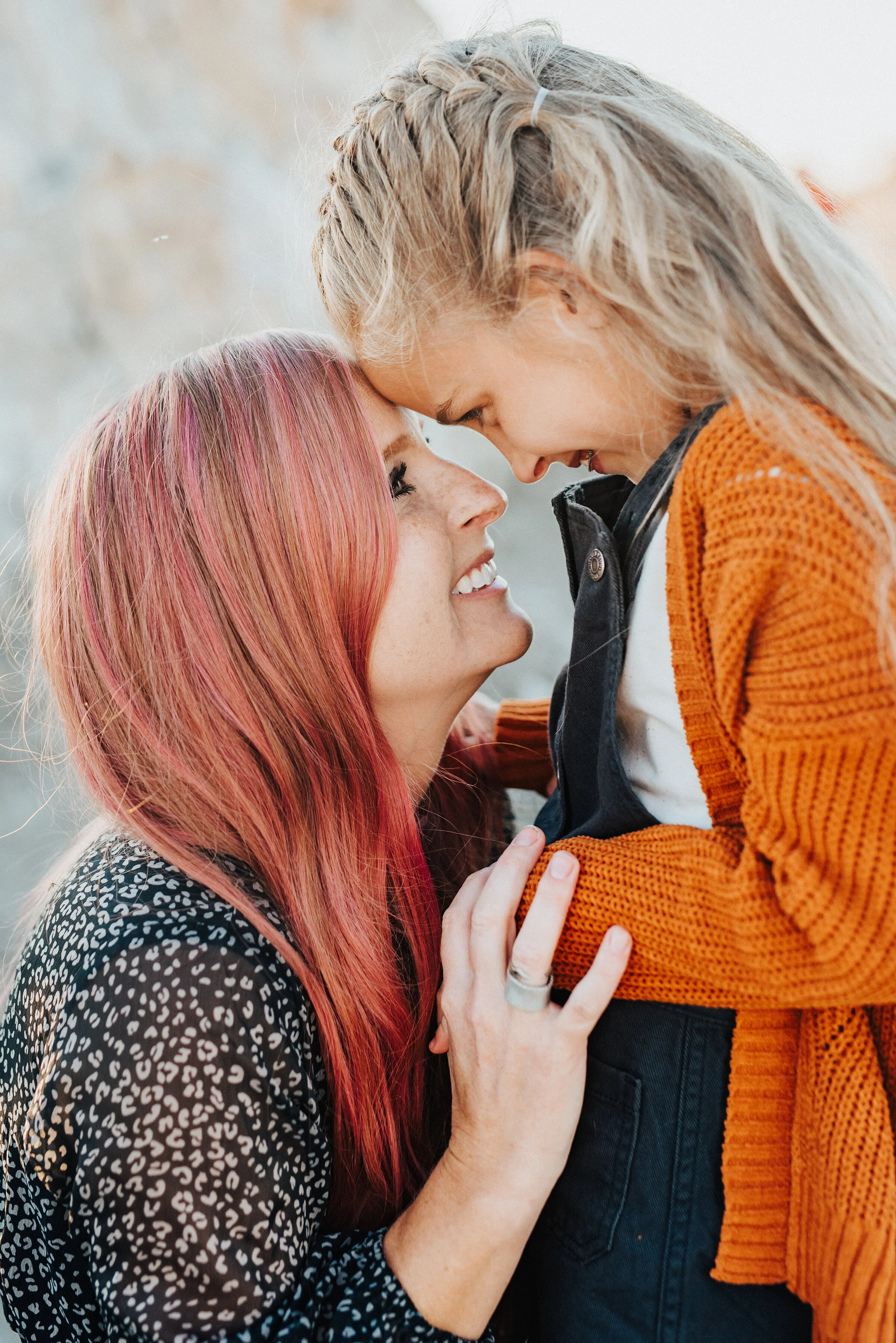  A beautiful mother and daughter share a sweet moment in a unique family photo shoot by Kristi Alyse Photography. Mother and daughter pose inspiration ideas and goals braided hair pink hair mother and daughter outfit inspiration ideas and goals famil