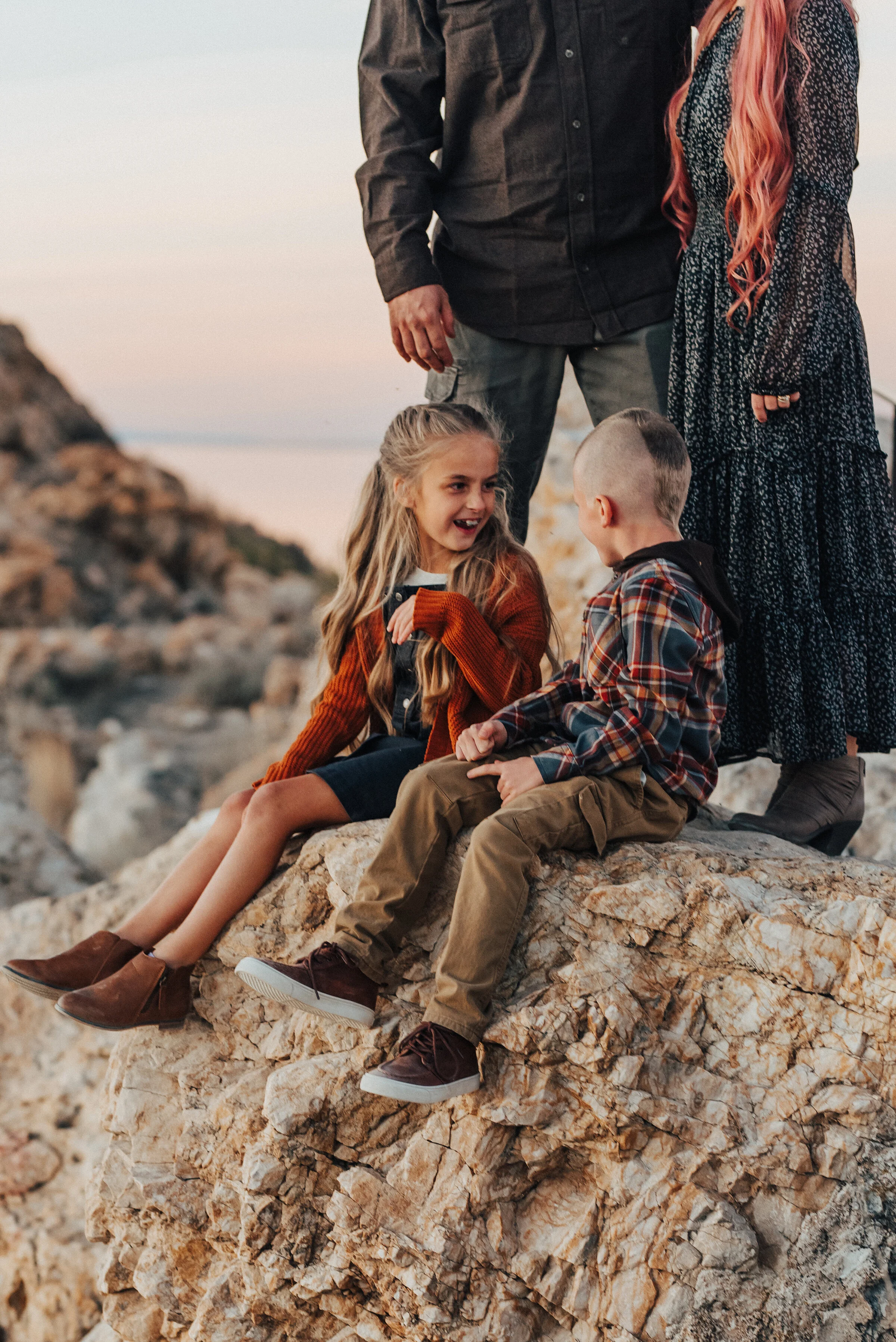  A close up family photo shoot with boy and girl laughing together. Beautiful family moment family photographer Kristi Alyse Photography professional Utah photographer Syracuse Utah unique family pics pink hair family pose inspiration ideas and goals