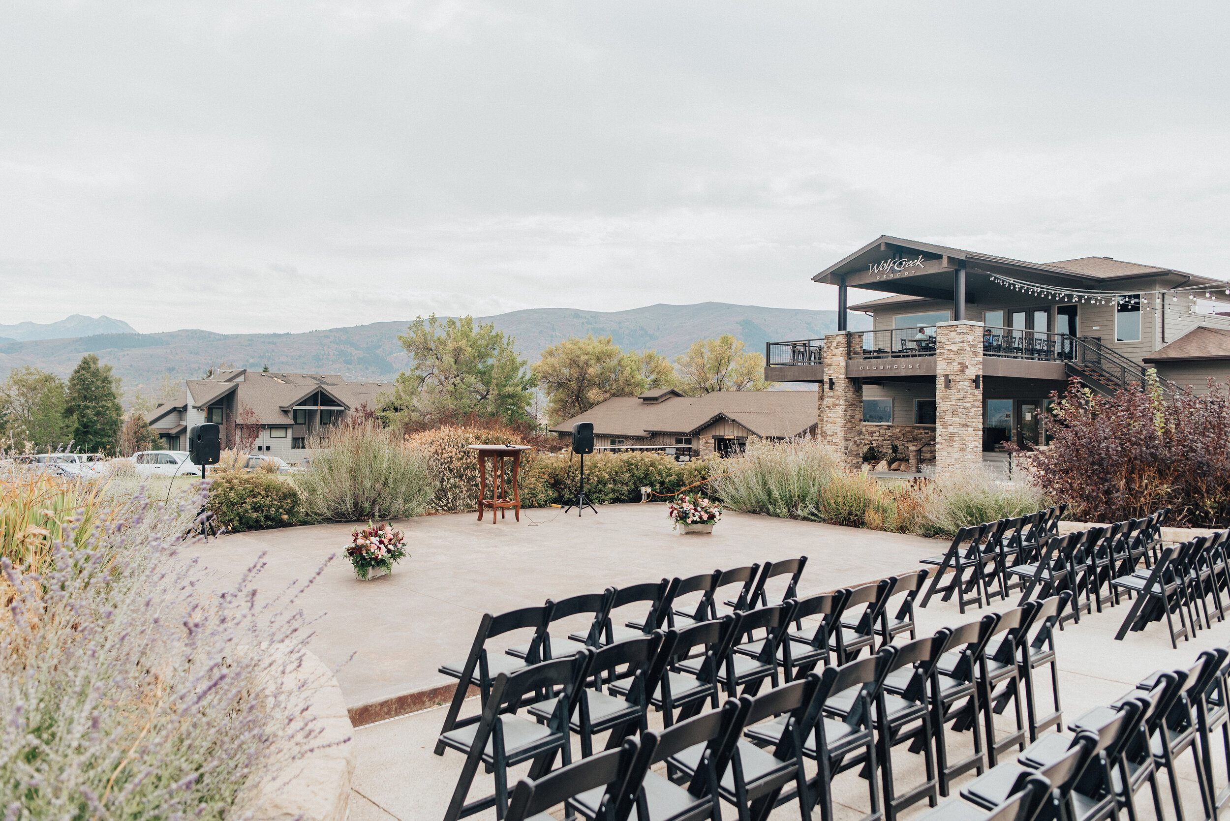 A stunning look of the wedding day ceremony in Logan, Utah by Kristi Alyse Photography. Ceremony background special moment the wedding day Kristi Alyse wedding ceremony inspo wedding details of the day black chairs floral details mountain backdrop w…