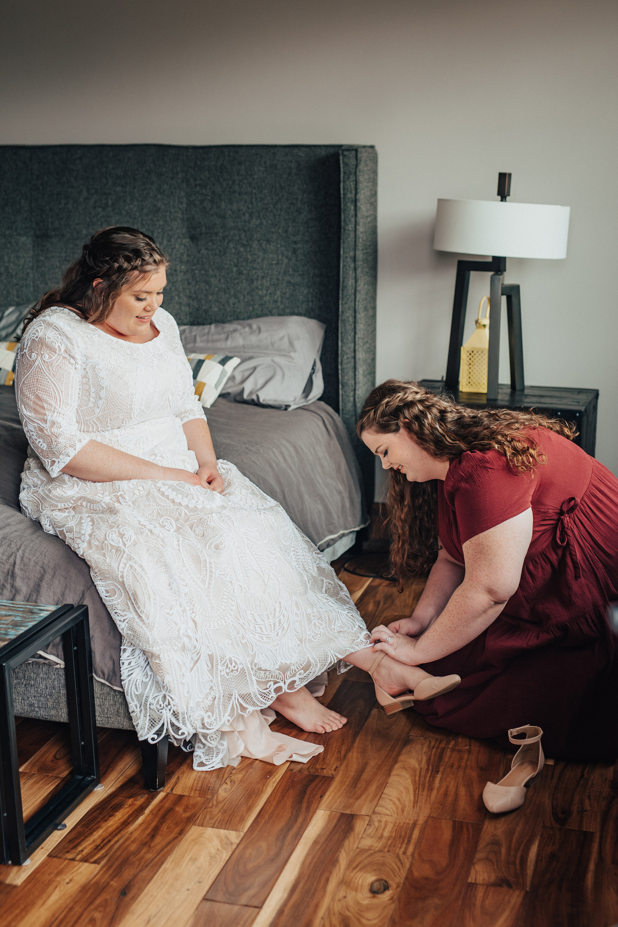  Getting ready for the big day with the help of bridesmaids in northern Utah shot by Kristi Alyse Photography. Bridesmaids maid of honor getting ready bridal shoe maroon red bridesmaid dress wedding dress tan flat shoes logan Utah big day inspiration meaningful moments captured Kristi Alyse photography #weddinginspo #loganutah #brideandgroom #utahbride #utahweddingphotographer #meaningfulmoment #weddingphotography #northernutahwedding #weddinghairstyles #weddingday #bridals 