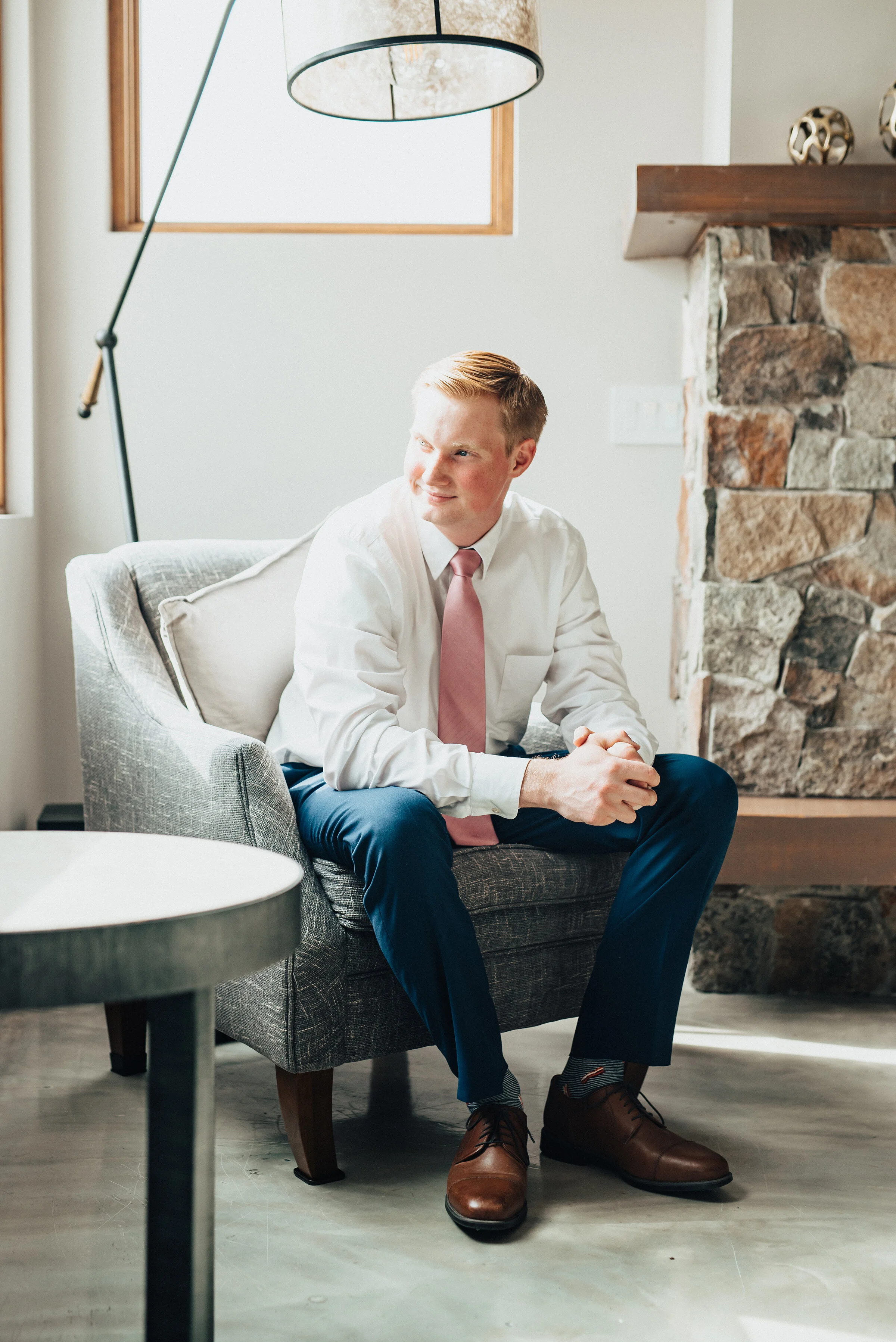 Handsome groom awaiting the big moment in Logan, Utah shot by Kristi Alyse Photography. Groom waiting blue suit pink tie brown shoes moments before wedding day northern Utah wedding indoor groom photo inspiration unique photography #weddinginspo #lo