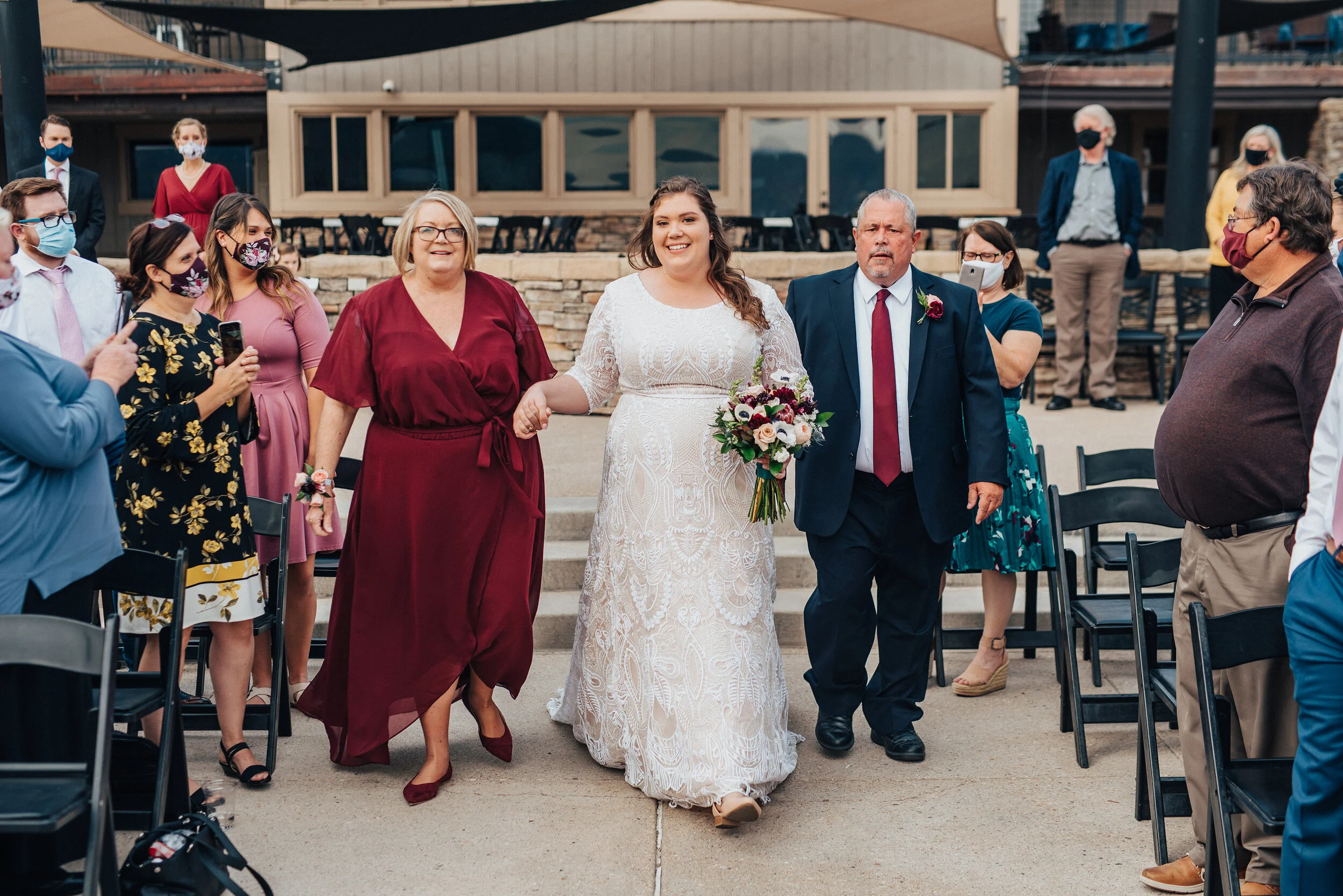 The moment of the bride walking down the aisle captured by Kristi Alyse Photography in northern Utah. Mother and father of the bride walk bride down the aisle meaningful moment quality wedding day photography Kristi Alyse wedding inspiration bride w…