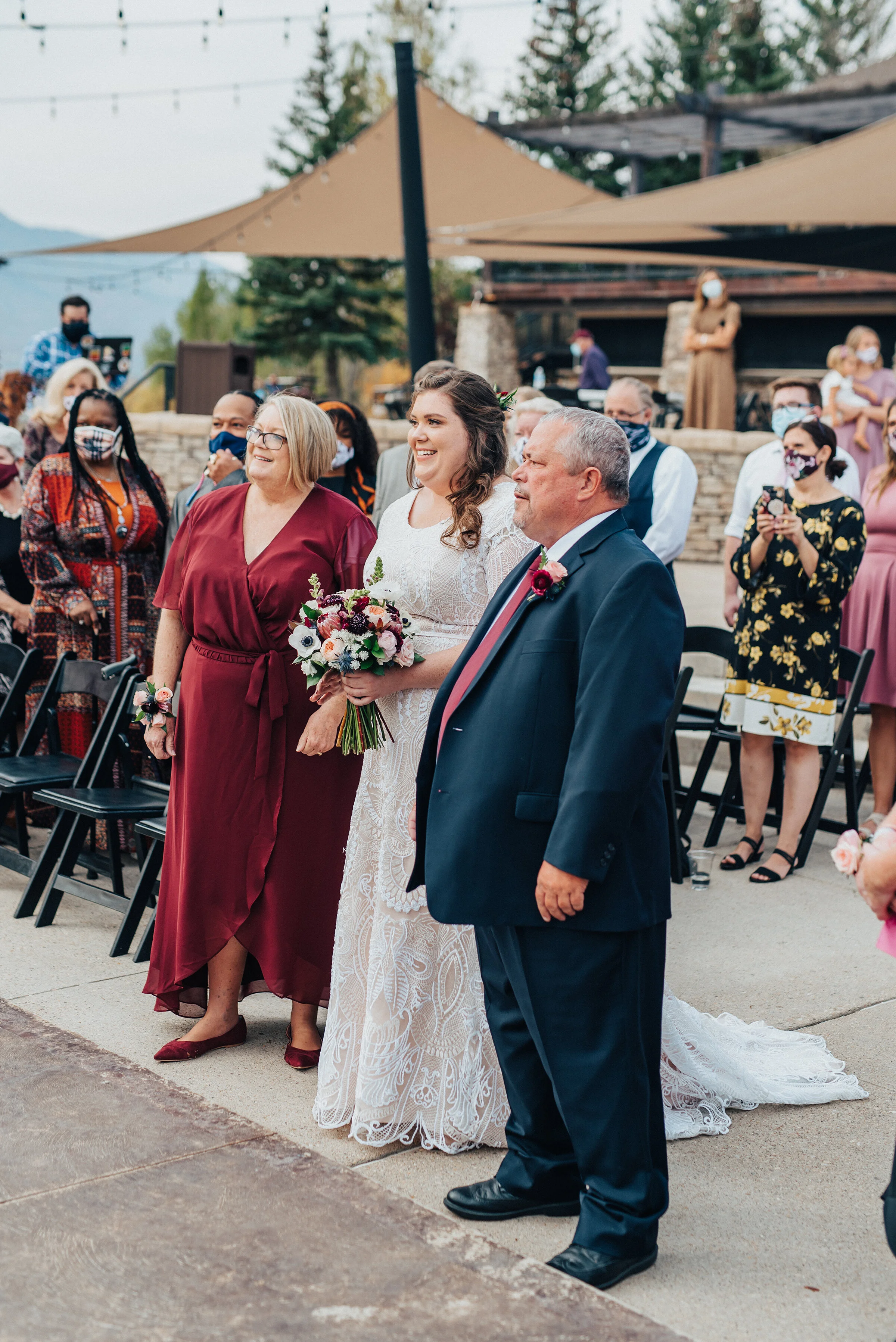  Beautiful bride with her parents before the wedding ceremony in northern Utah captured by Kristi Alyse Photography. Wedding day photography captures family mother daughter father wedding ceremony logan Utah bride meaningful moments classy floral bou