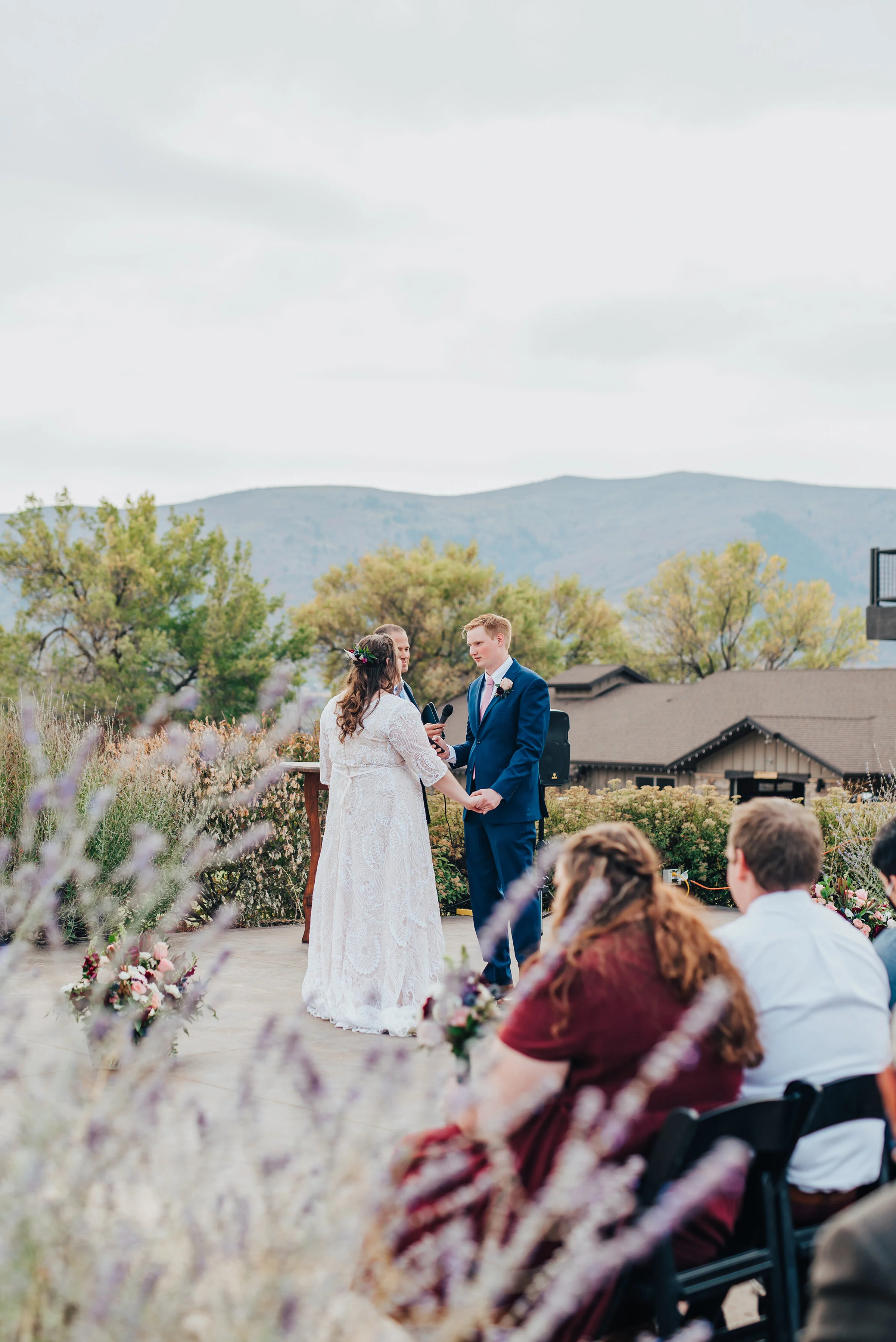  Bride and groom holding hands during their beautiful ceremony in northern Utah shot by Kristi Alyse Photography. Meaningful moment in wedding ceremony wedding day photography Utah bride logan Utah mountain background adventure love story I do photog