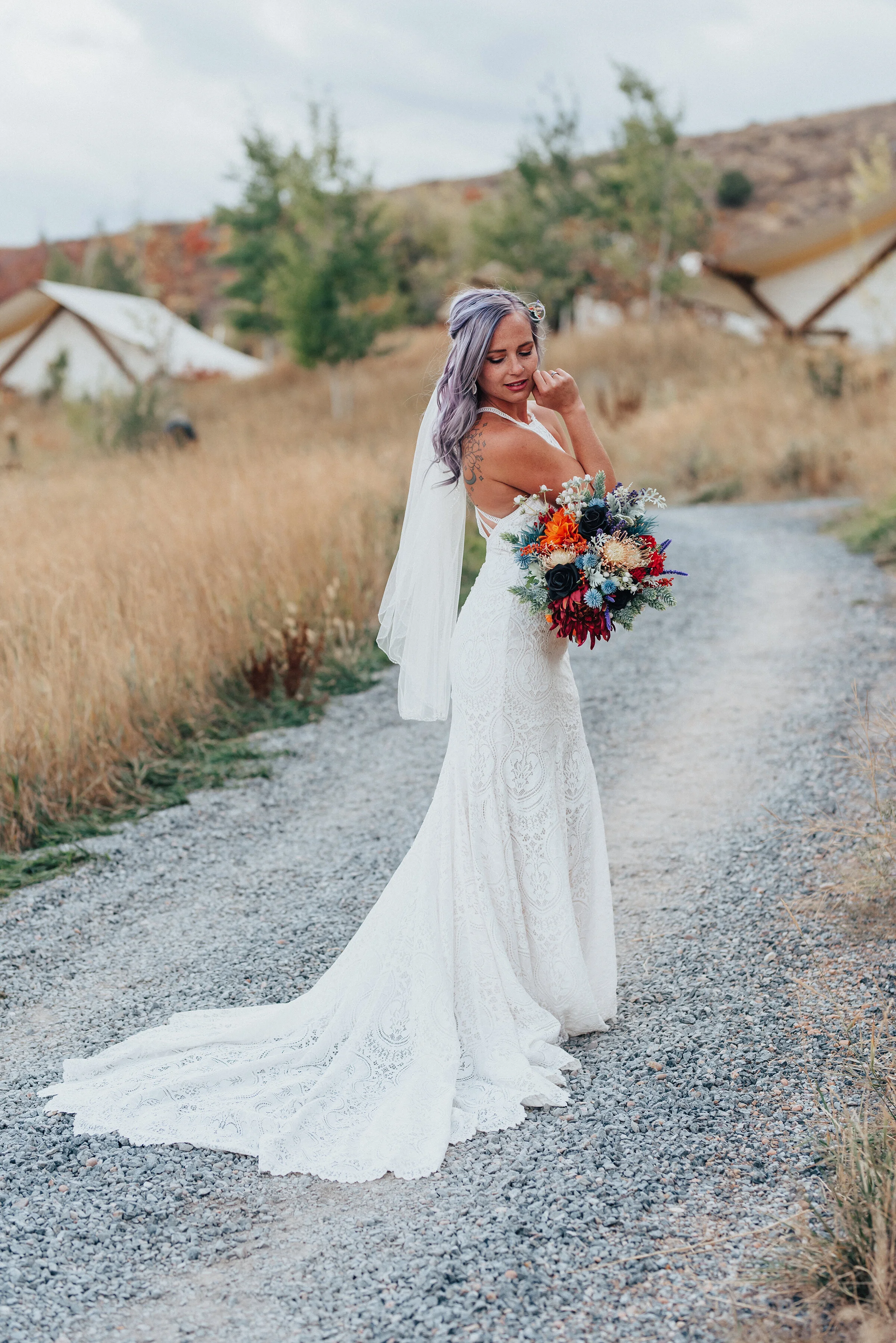  Beautiful bride with purple hair and lace dress and long train with veil and boho bridal bouquet in this styled shoot by Kristi Alyse Photography in Logan Utah. boho wedding flowers orange blue bridal bouquet lace white dress long train veil norther
