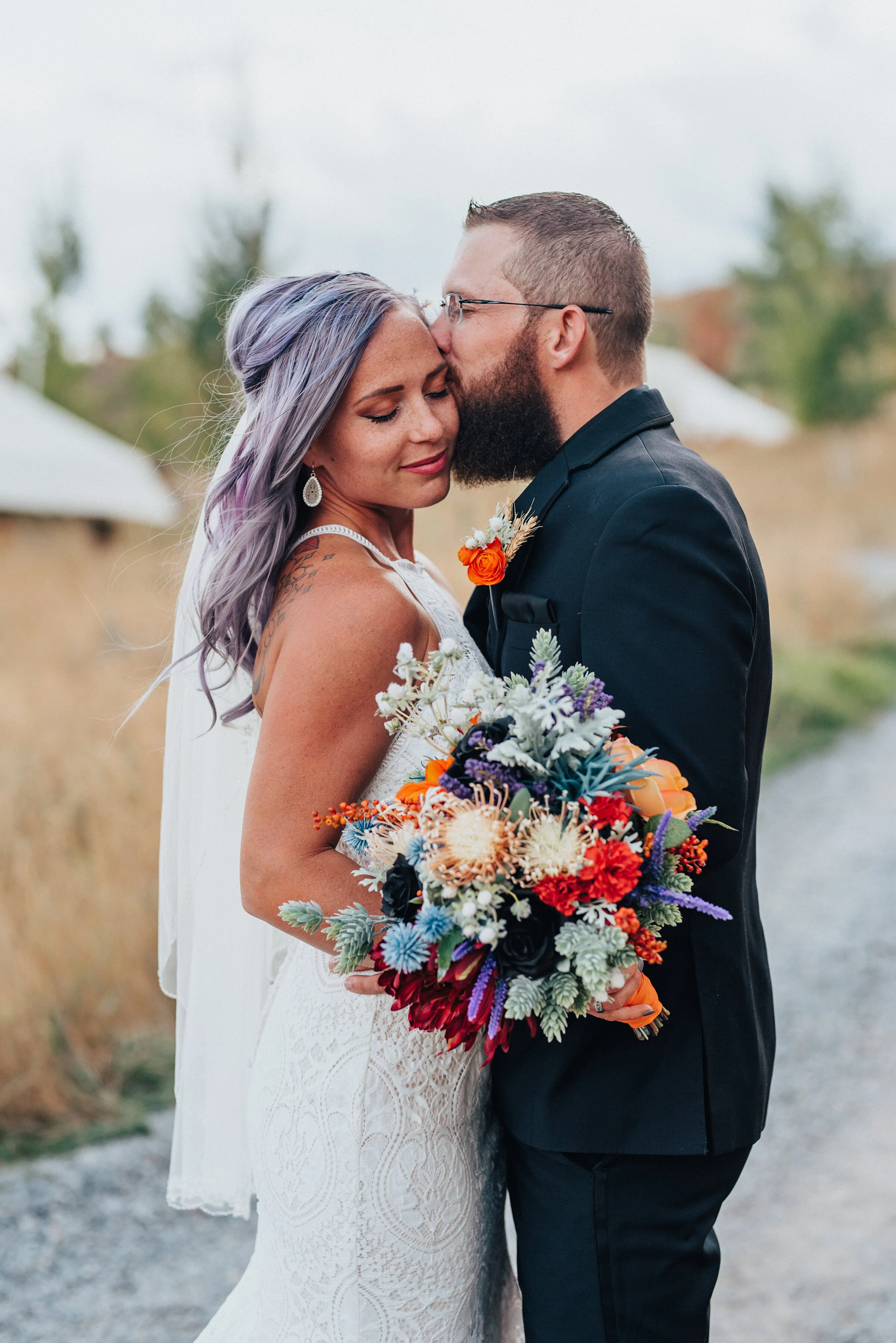  Boho bride and groom with purple hair and lace dress and black suit with orange and blue flowers in this styled shoot in Logan Utah by Krist Alyse Photography. northern utah quality photography meaningful photography wedding and family photographer 