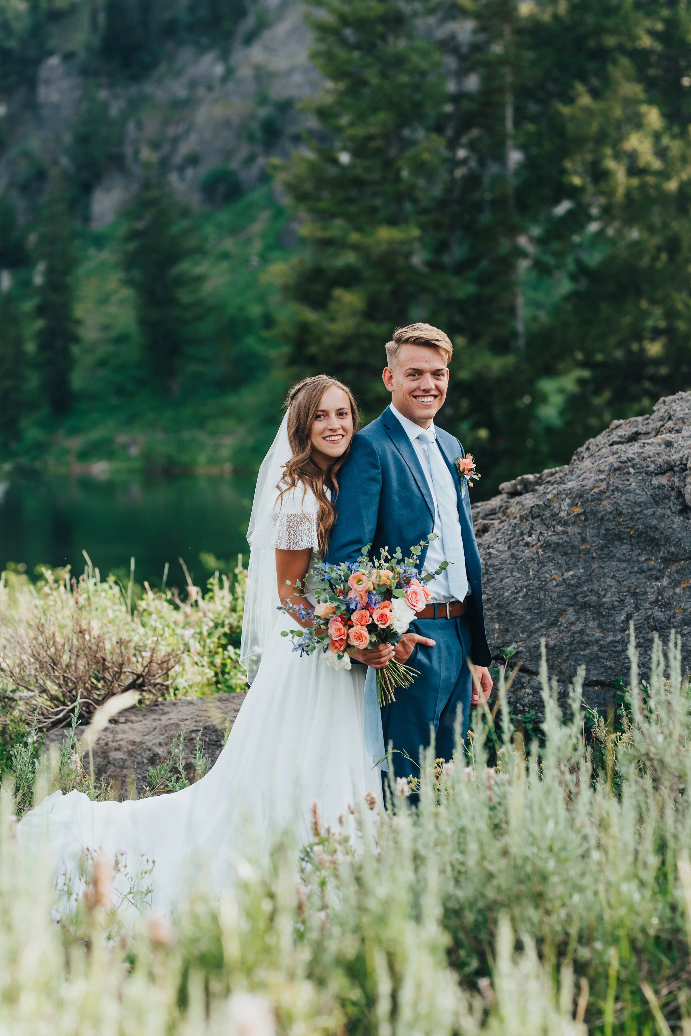  Gorgeous wedding formals of a modest bride and a groom in a blue suit set against the pine trees of Tony Grove. Utah wedding formals at Tony Grove wedding bridals in the mountains pine tree wedding photography adventurous bride to be wedding plannin
