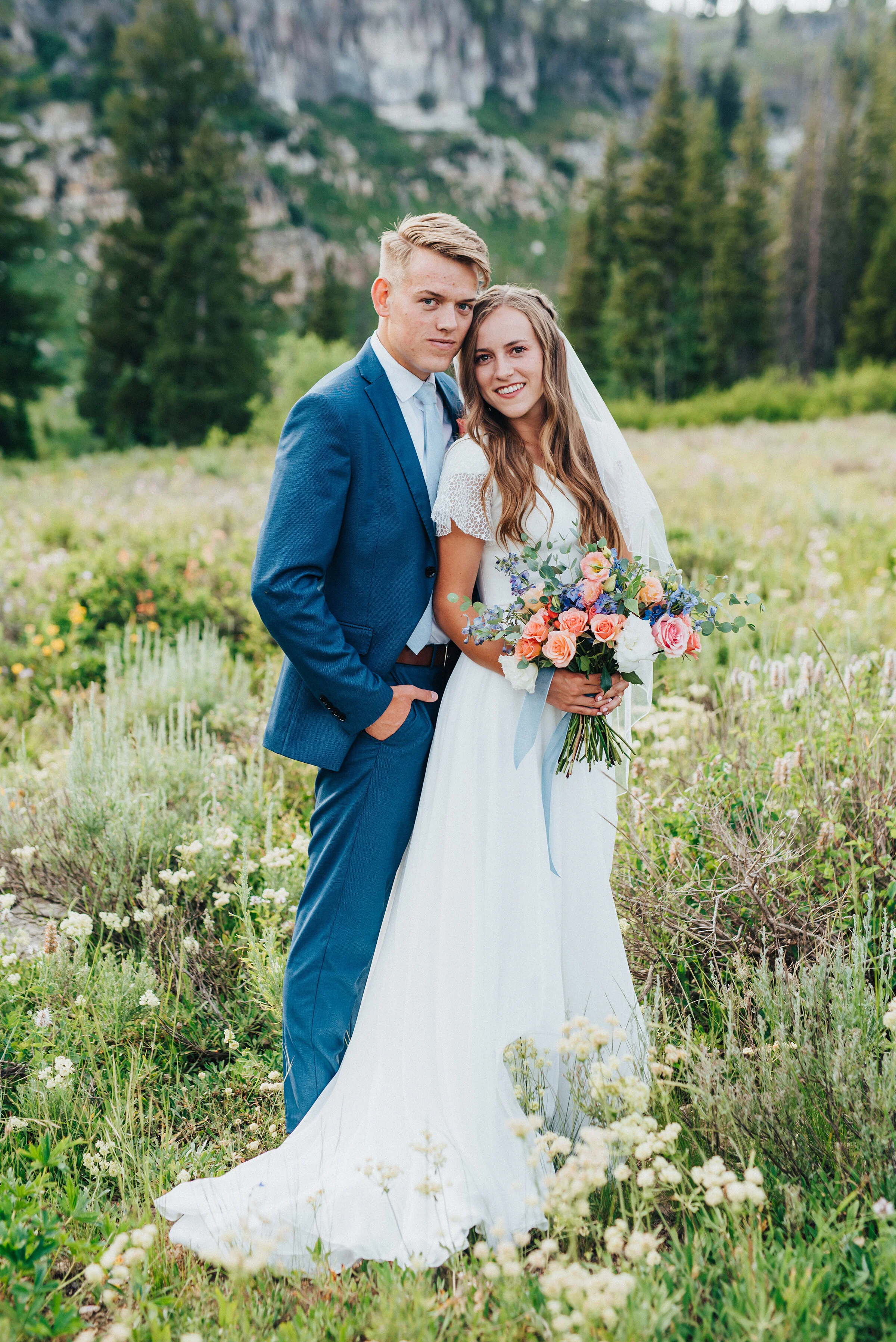  Gorgeous wedding formals of a modest bride and a groom in a blue suit set against the pine trees of Tony Grove. Utah wedding formals at Tony Grove wedding bridals in the mountains pine tree wedding photography adventurous bride to be wedding plannin
