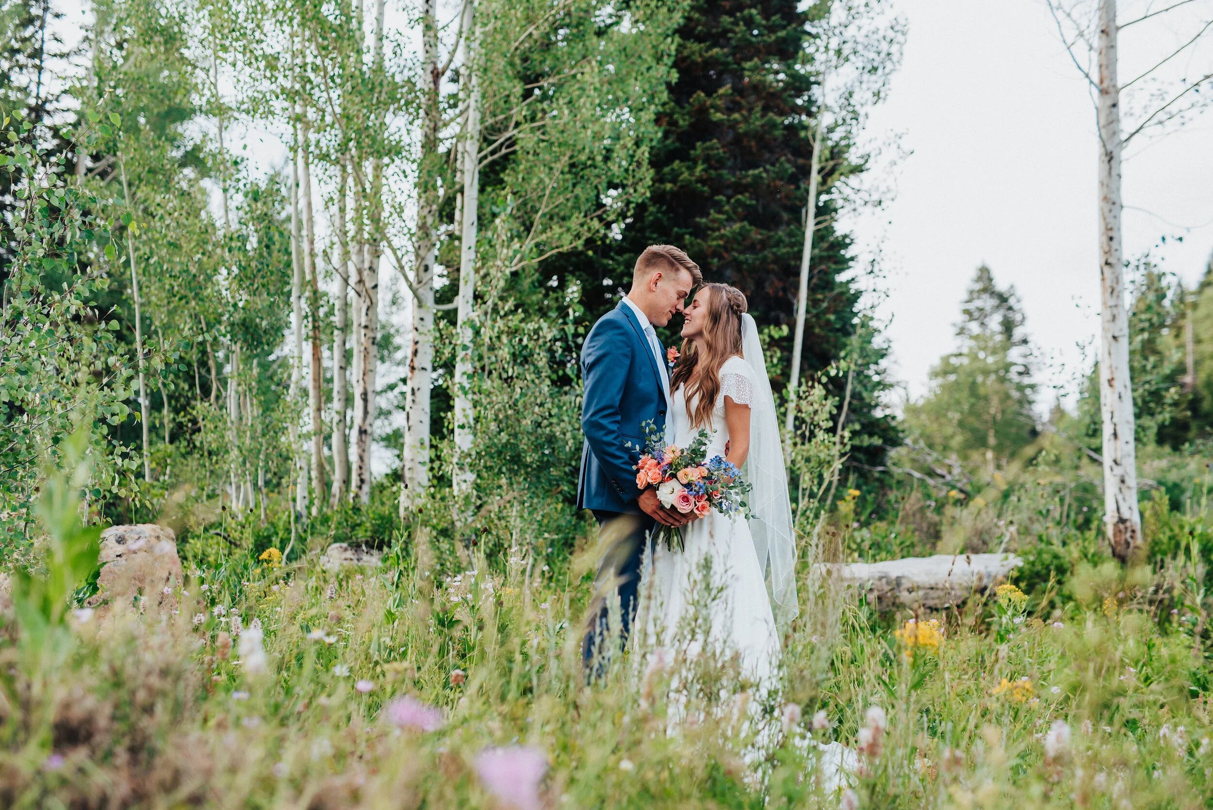  Gorgeous bride and groom surrounded by lush green brush and trees at tony grove in northern utah captured by a northern utah wedding photographer. Northern utah wedding photography wedding formals at tony grove utah bride and groom outdoor wedding p