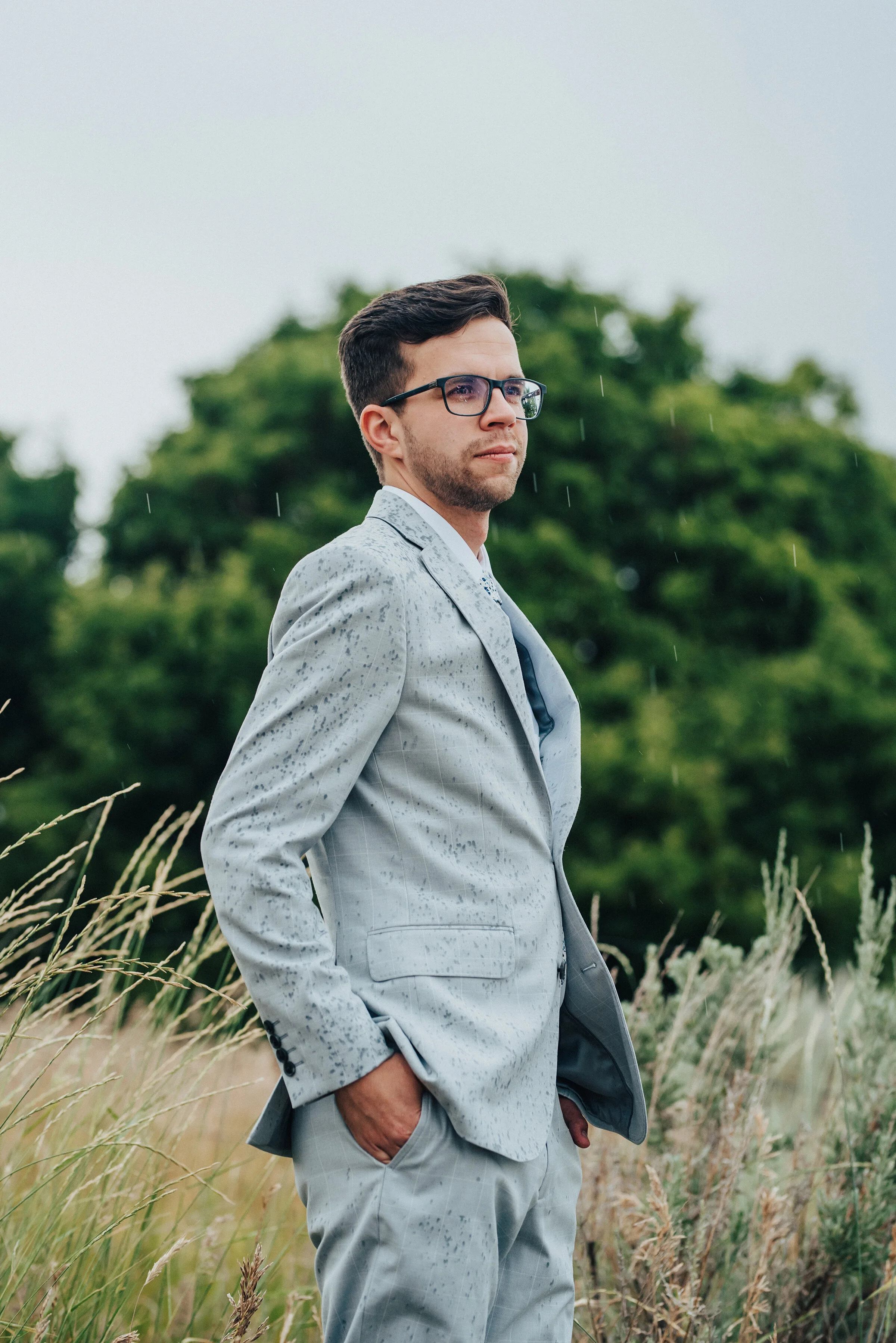  A windy, rain-filled bridal session by Kristi Alyse Photography in Mendon, Utah did not waver the confidence in this groom’s wedding portrait. professional Mendon utah wedding photographer, light gray white plaid wedding suit, black framed wedding g