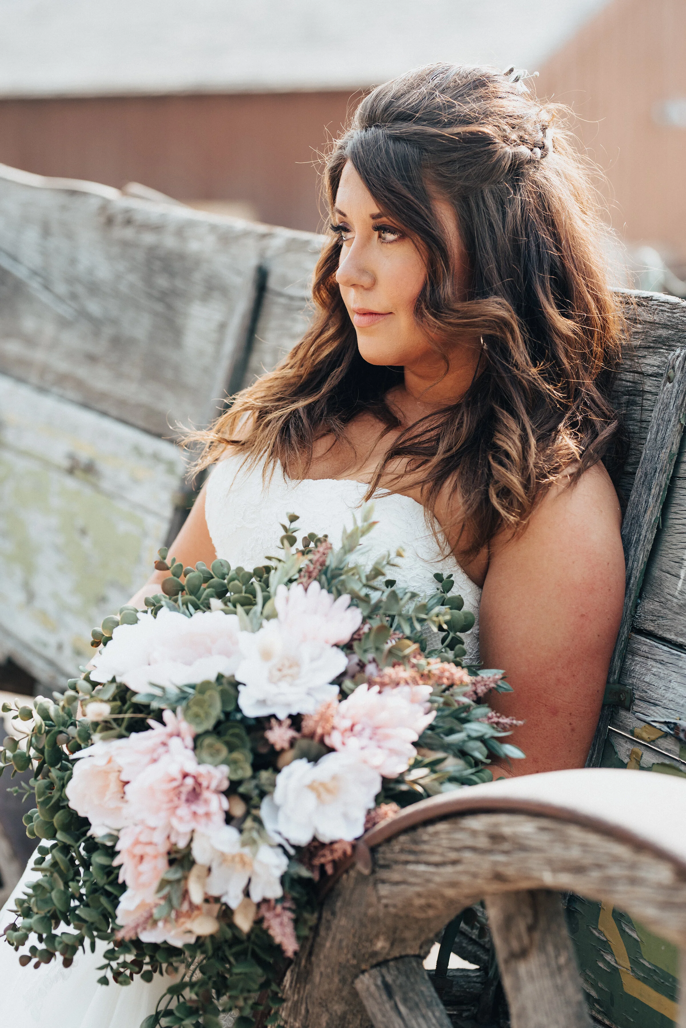  A rustic wooden wagon proves to be the perfect backdrop for these wedding bridals taken by Kristi Alyse Photography in Logan, Utah. blush pink and white bridal bouquet, wedding briad, half up curled bridal hair, sweetheart strapless lace wedding dre