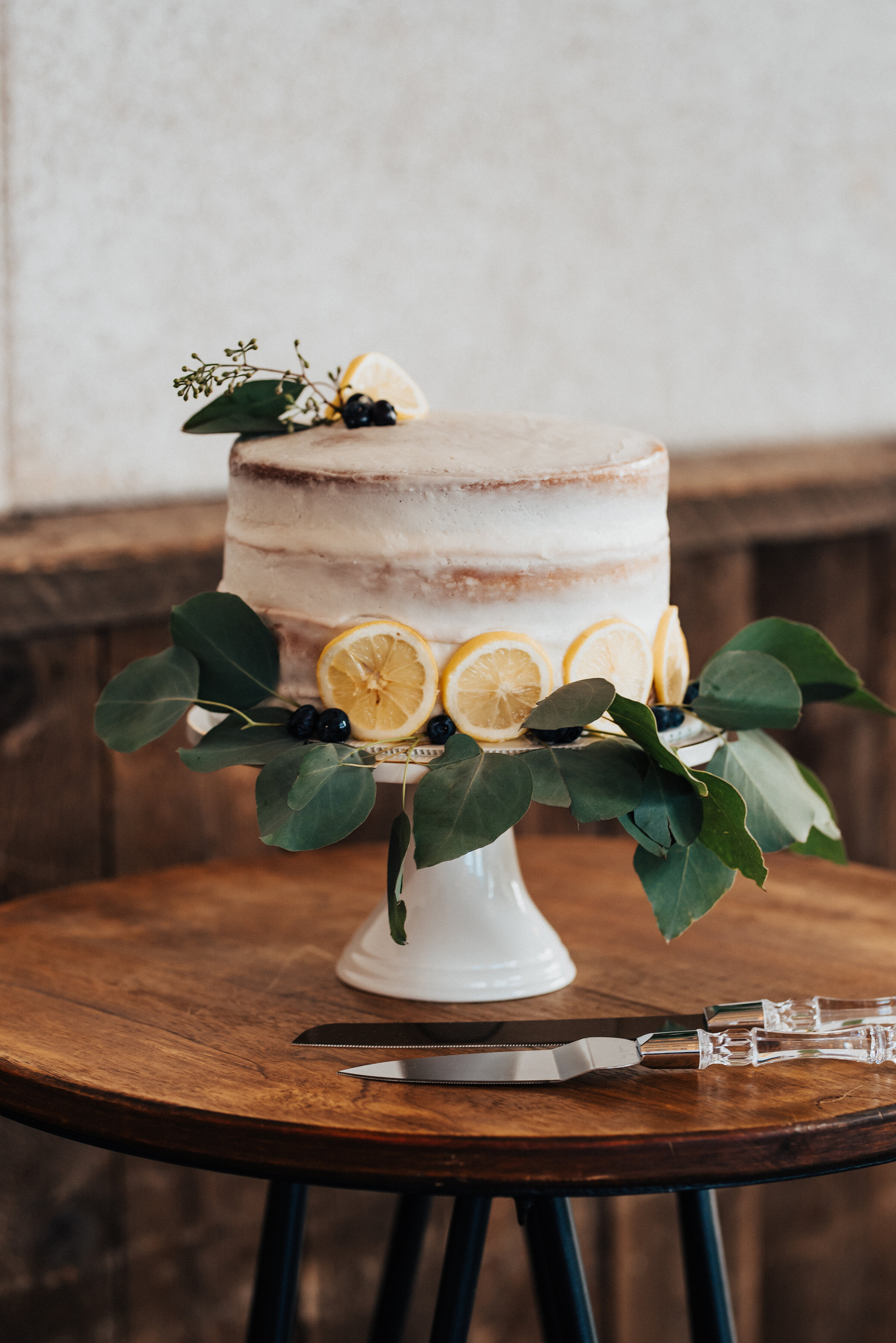  Kristi Alyse Photography leaves no wedding detail unnoticed as she photographs a bohemian-styled wedding reception in Provo, Utah. bohemian wedding cake, crumb coated wedding cake, orange flavored wedding cake, wedding cake embellished with eucalypt
