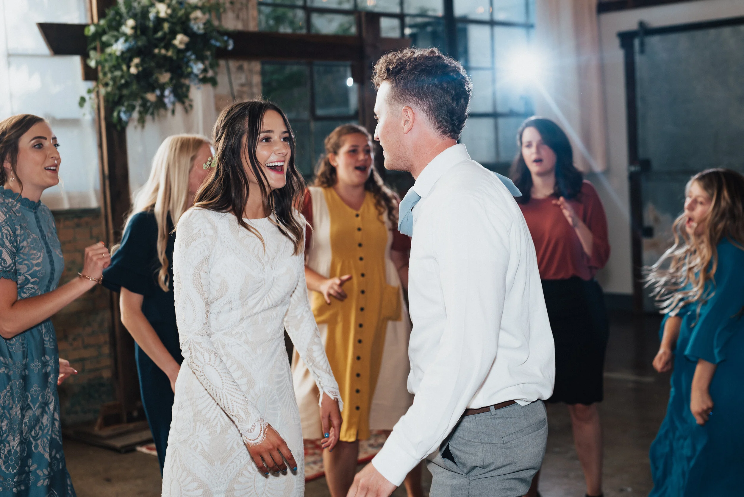  Fun and energy on the dance floor - Kristi Alyse Photography captures newlyweds having fun at their wedding reception at the Bright Building in Provo, Utah. wooden floral wedding arch, reception dance floor, bright building provo utah, professional 