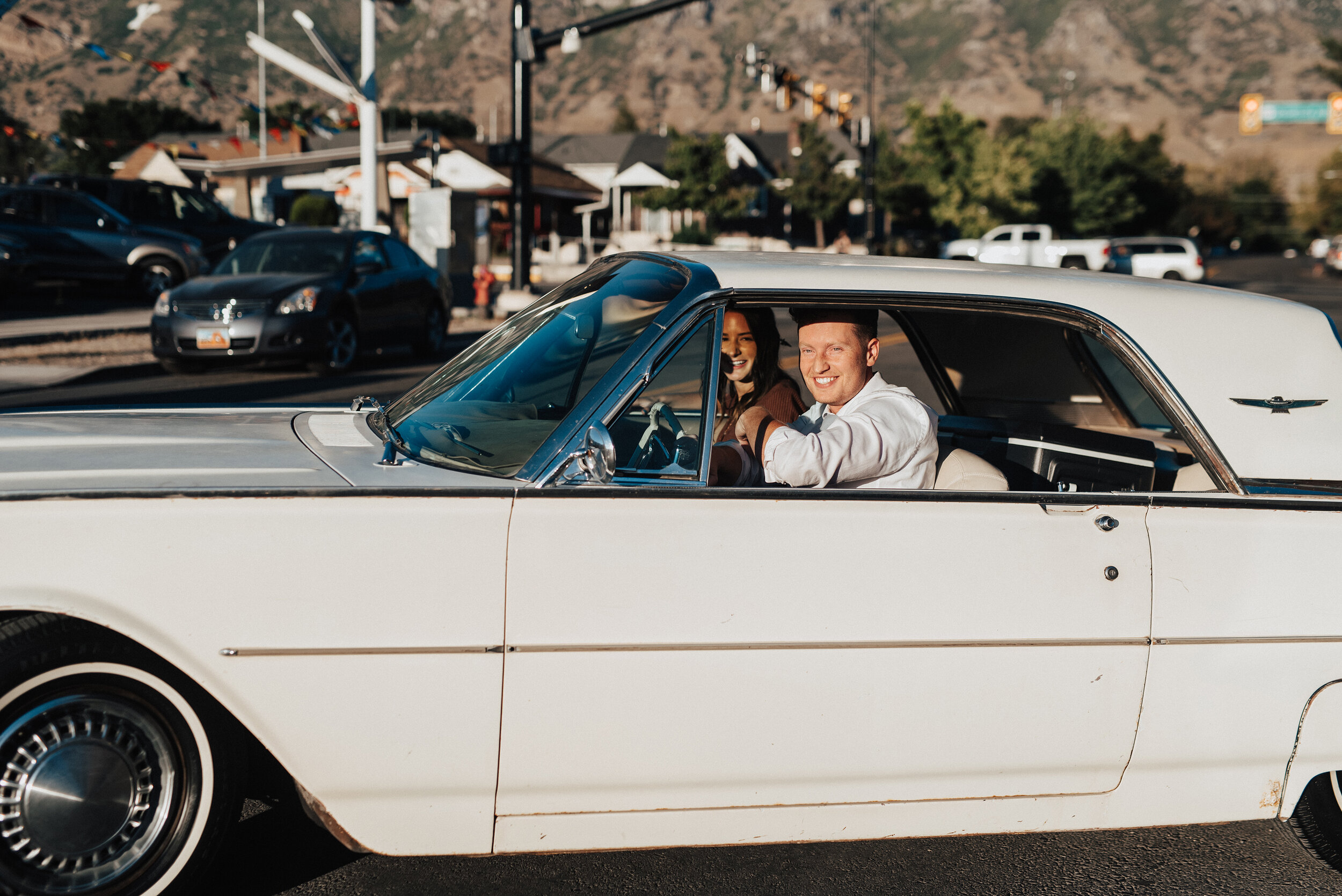  Kristi Alyse Photography captures newlyweds speed away in their vintage white Chrysler getaway car in Provo, Utah. vintage car, white vintage Chrysler, getaway car, vintage wedding, bohemian styled wedding reception, professional provo utah wedding 